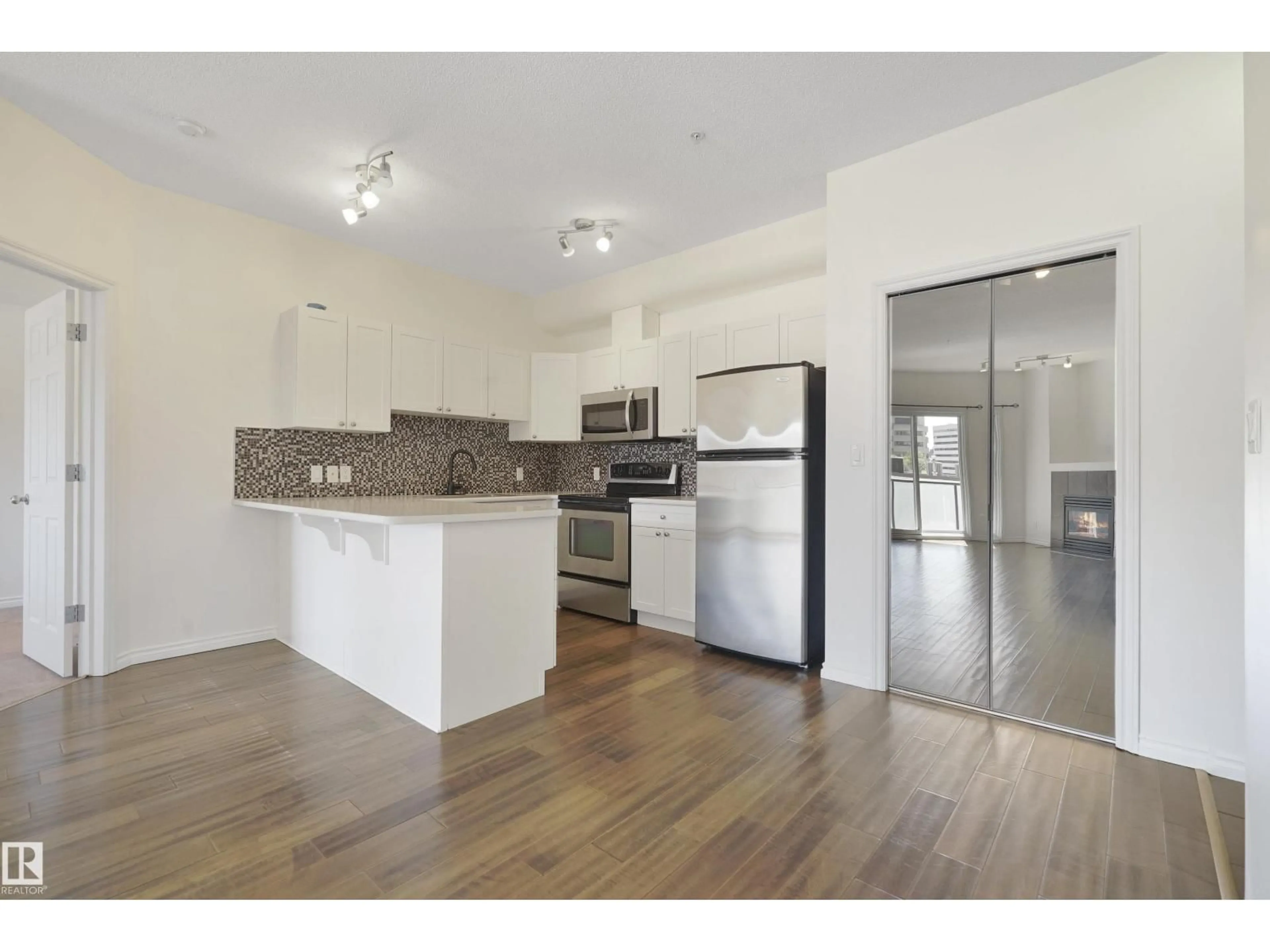 Open concept kitchen, wood/laminate floor for #414 - 10235 112 ST, Edmonton Alberta T5K1M7