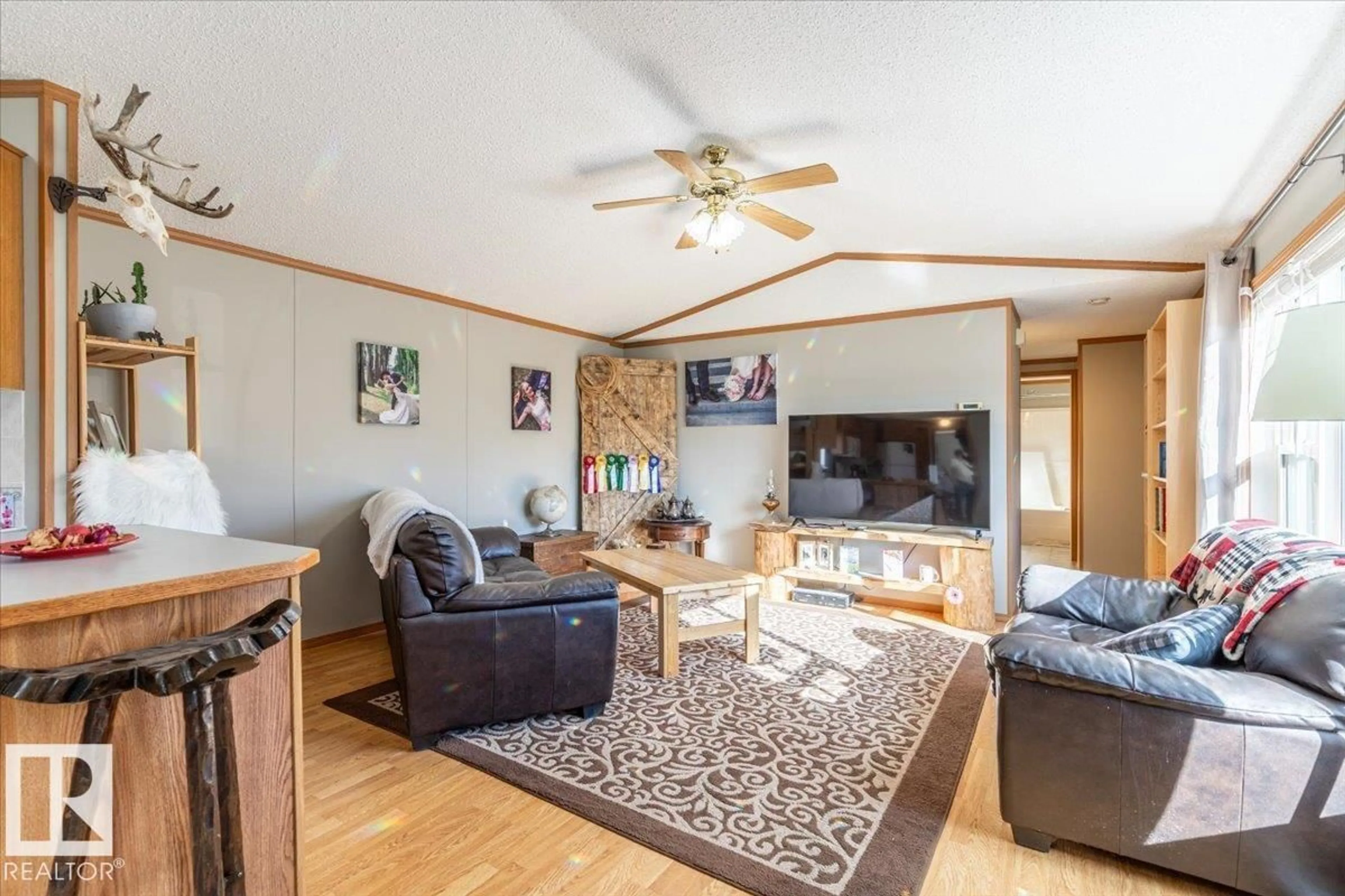 Living room with furniture, wood/laminate floor for 28154 TWP RD, Rural Leduc County Alberta T0C2P0