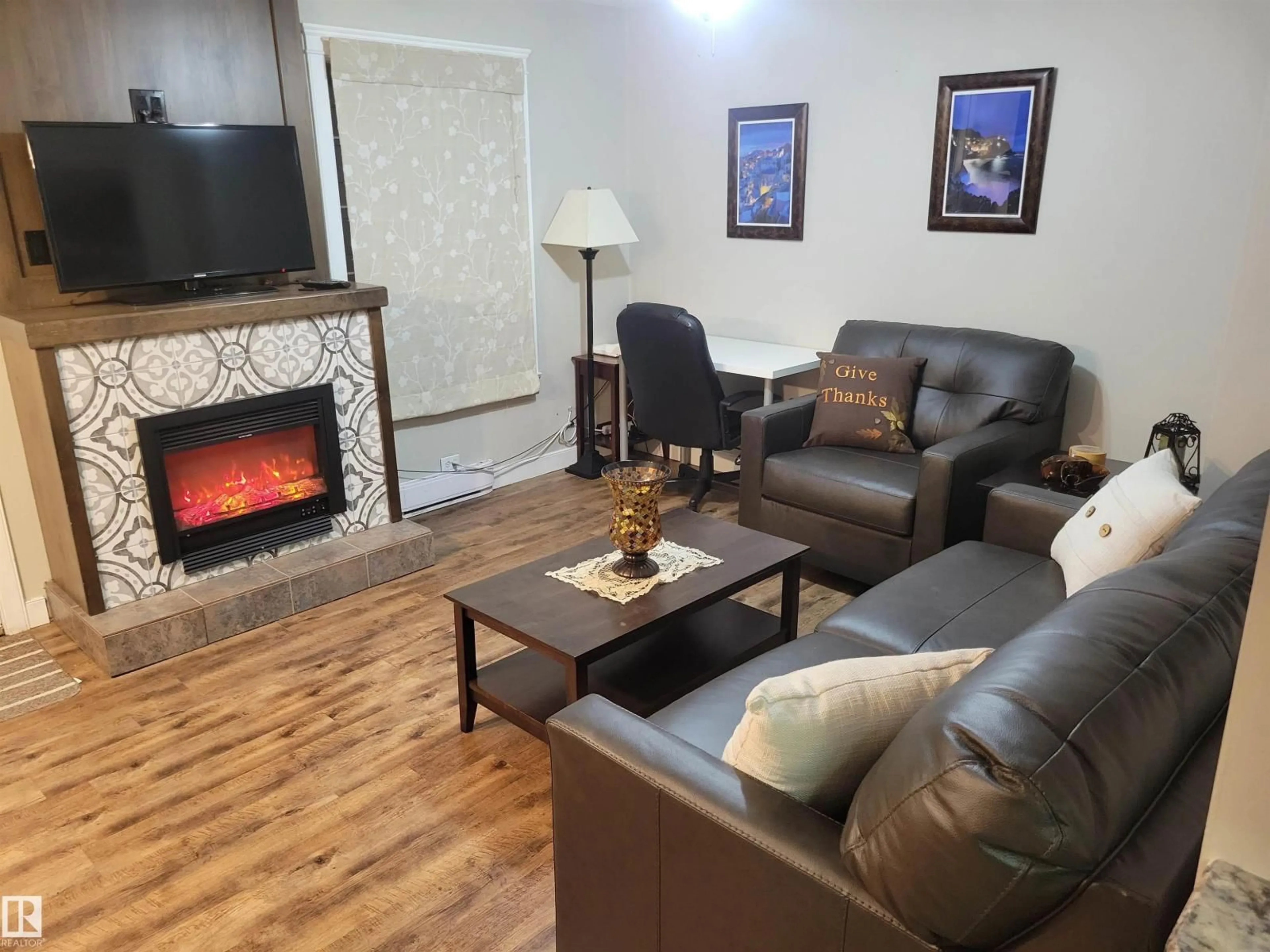 Living room with furniture, wood/laminate floor for 10115 105 ST, Westlock Alberta T7P1V9