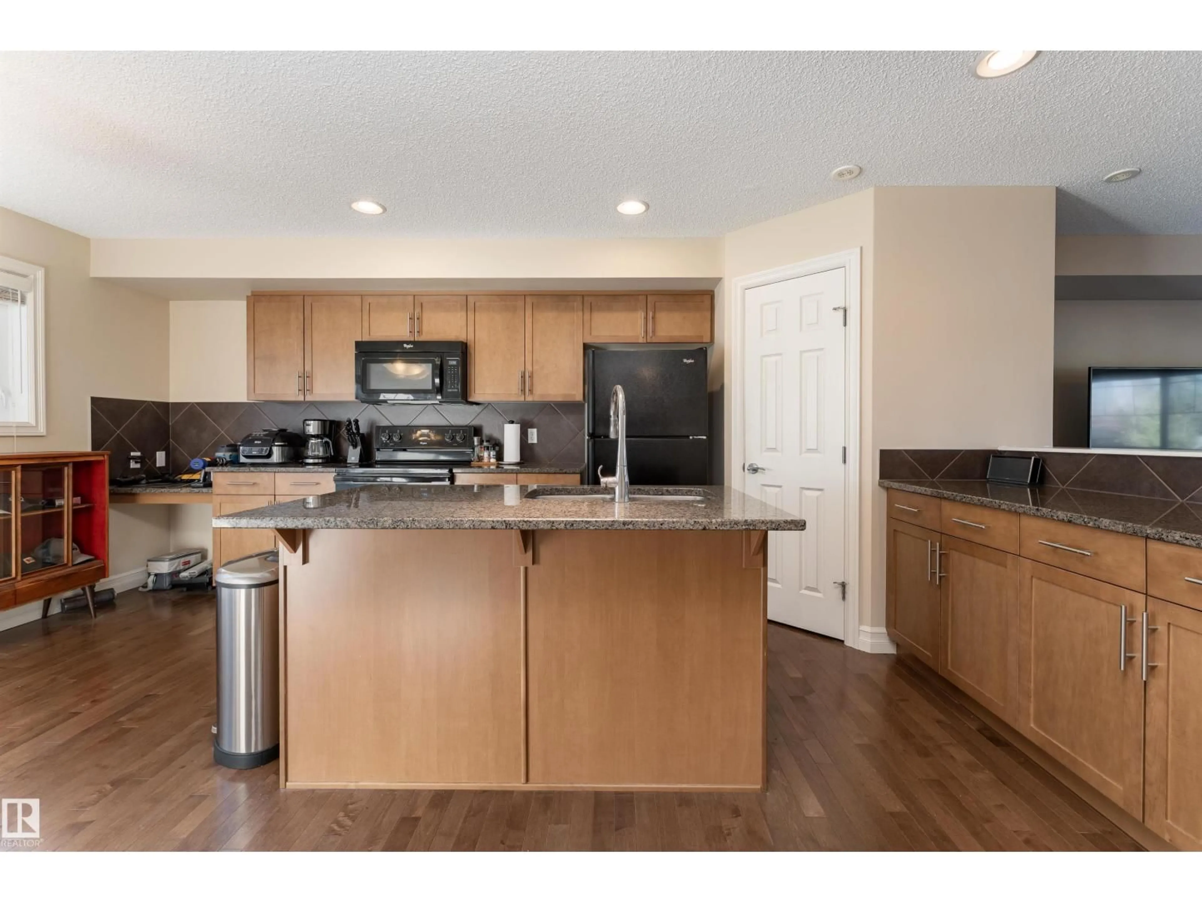 Open concept kitchen, wood/laminate floor for #133 - 2336 ASPEN TR, Sherwood Park Alberta T8H0J1