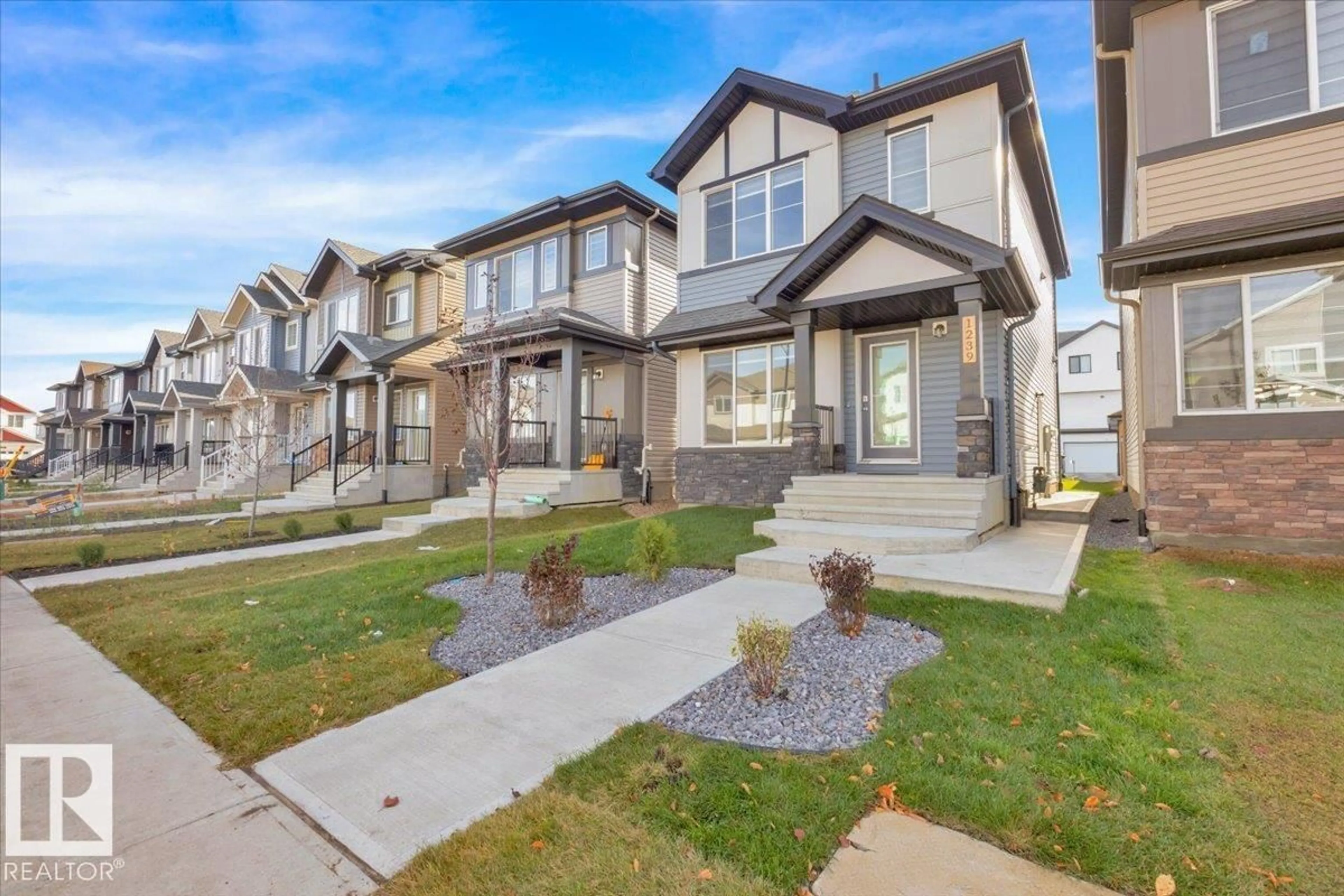 Home with vinyl exterior material, street for 1239 16 AV, Edmonton Alberta T6T0S9