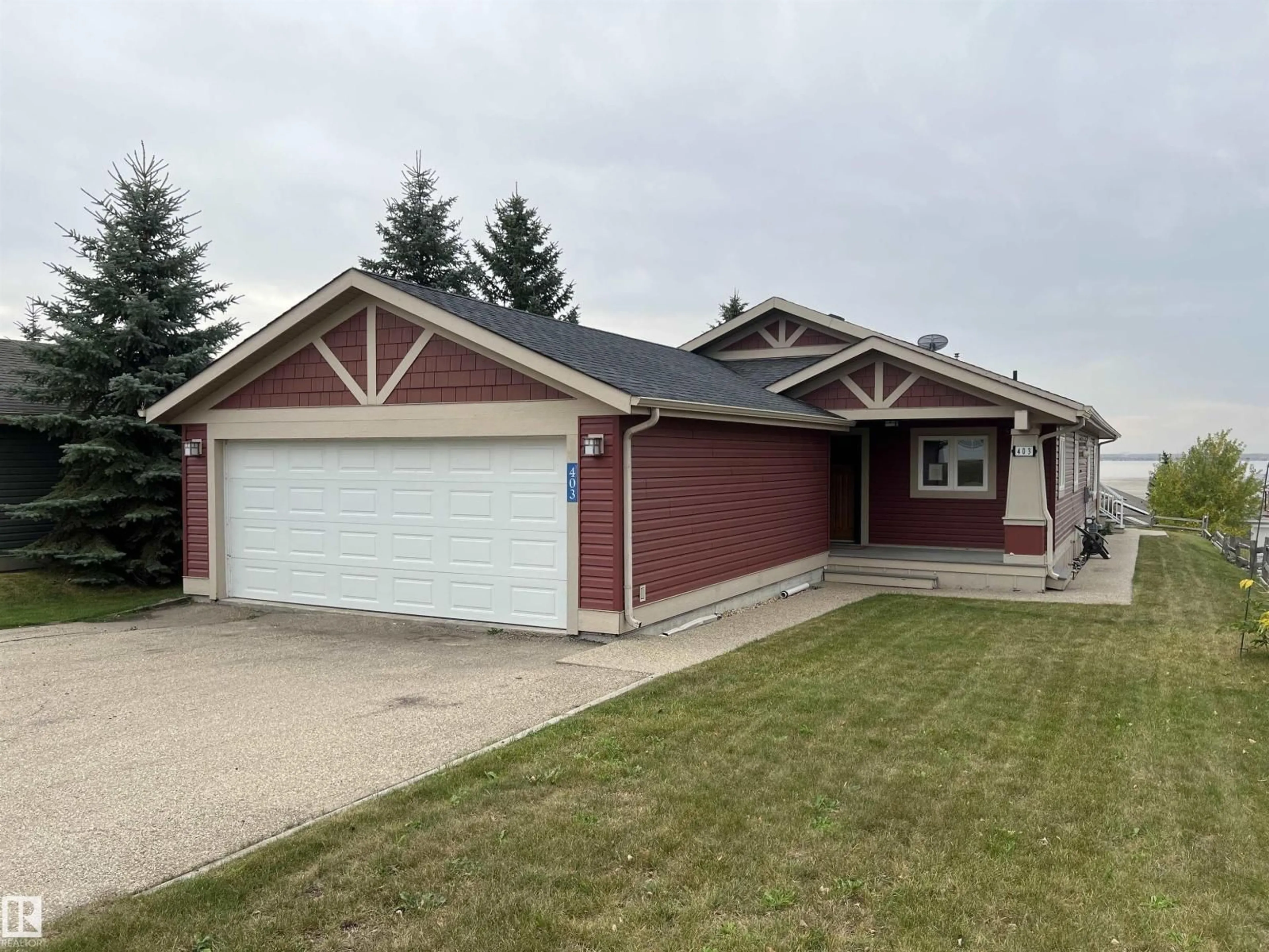 Home with vinyl exterior material, street for #403 - 55101 STE. ANNE TR, Rural Lac Ste. Anne County Alberta T0E1A1