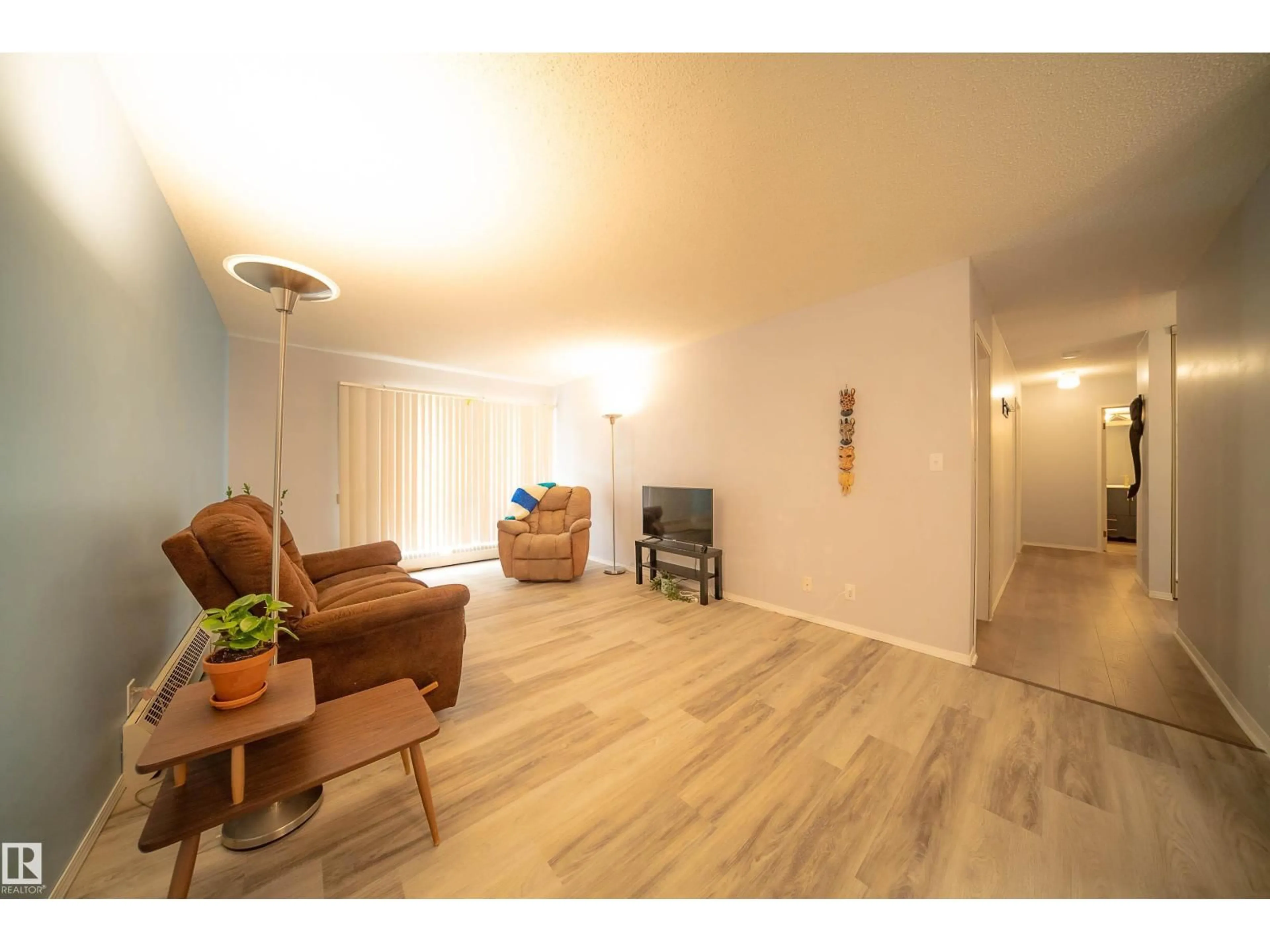 Living room with furniture, wood/laminate floor for 408 - 10511 19 AV, Edmonton Alberta T6J5S8