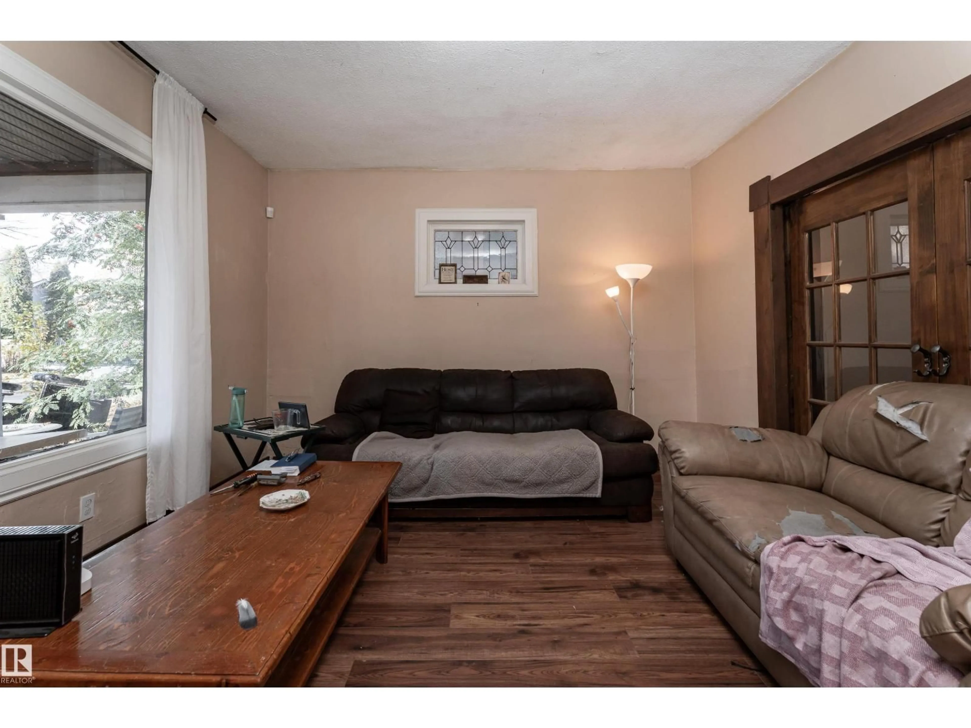 Living room with furniture, wood/laminate floor for NW - 10755 93 ST, Edmonton Alberta T5H1Y4