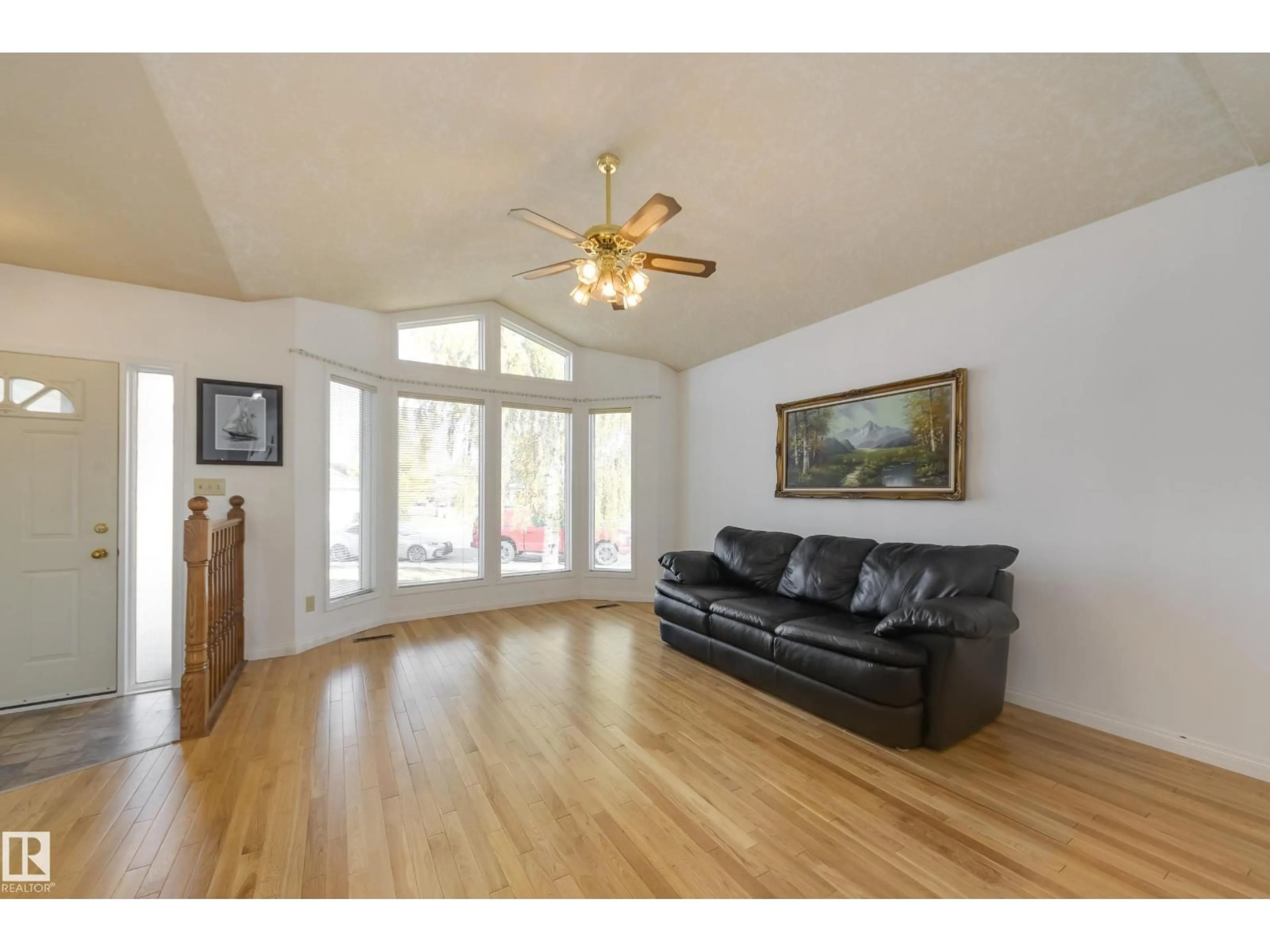 Living room with furniture, wood/laminate floor for 10315 154 AV, Edmonton Alberta T5X5R1
