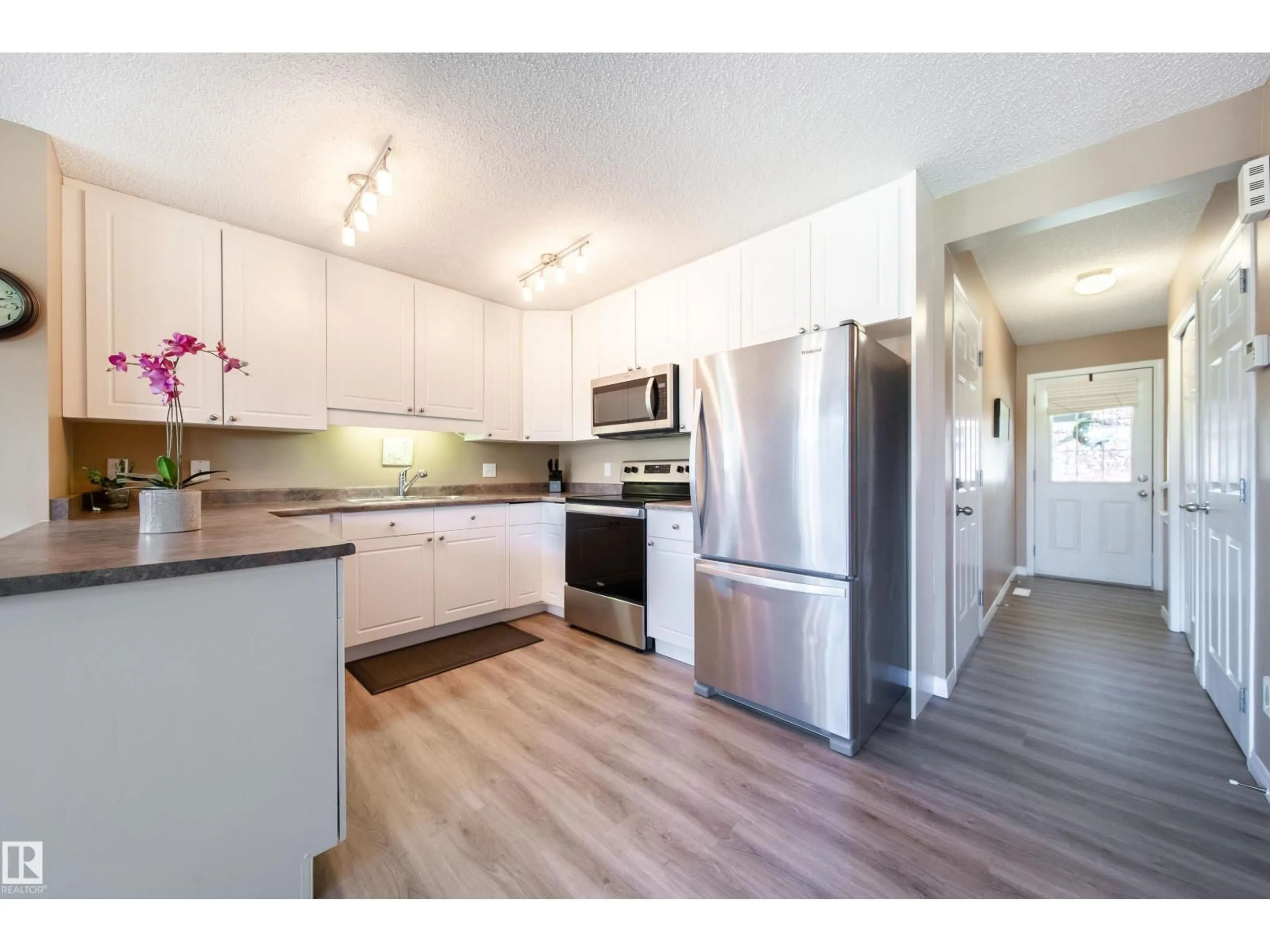 Open concept kitchen, wood/laminate floor for 12208 16 AV, Edmonton Alberta T6W1L8