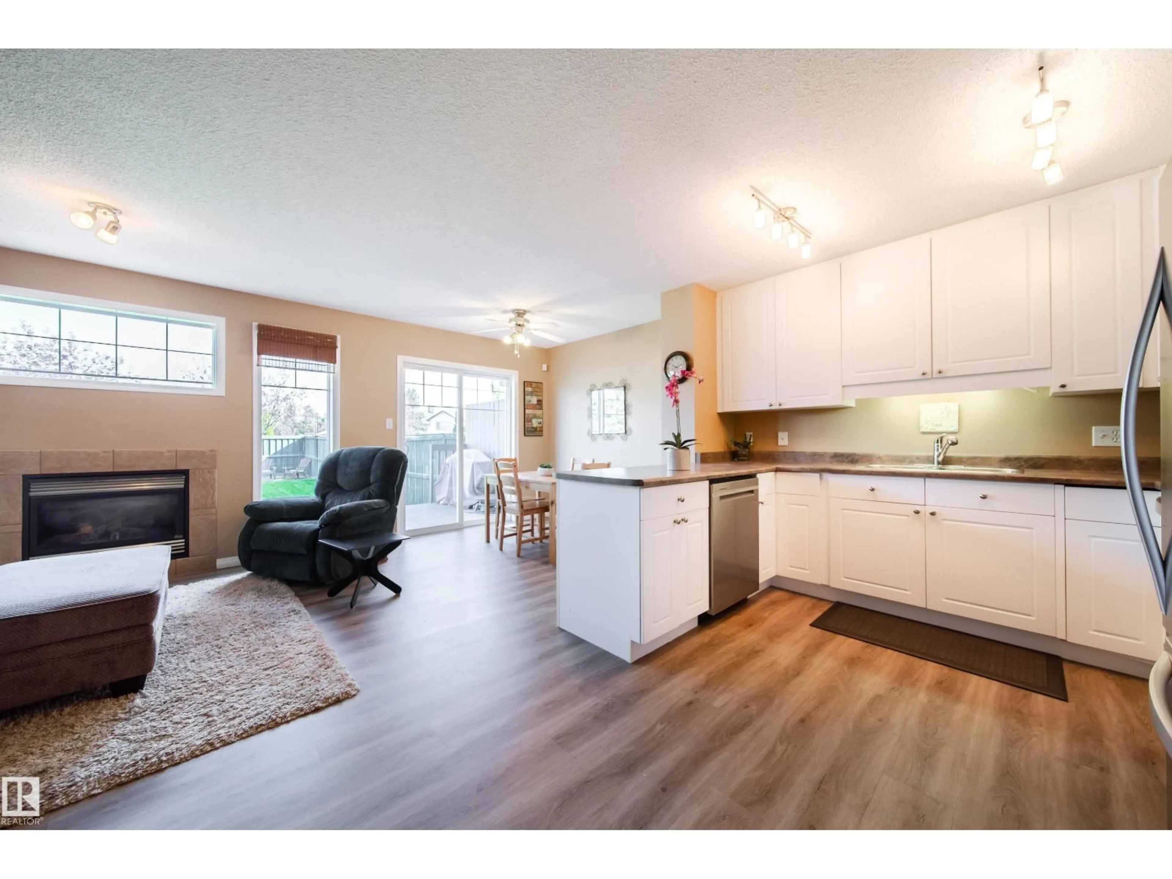 Open concept kitchen, wood/laminate floor for 12208 16 AV, Edmonton Alberta T6W1L8