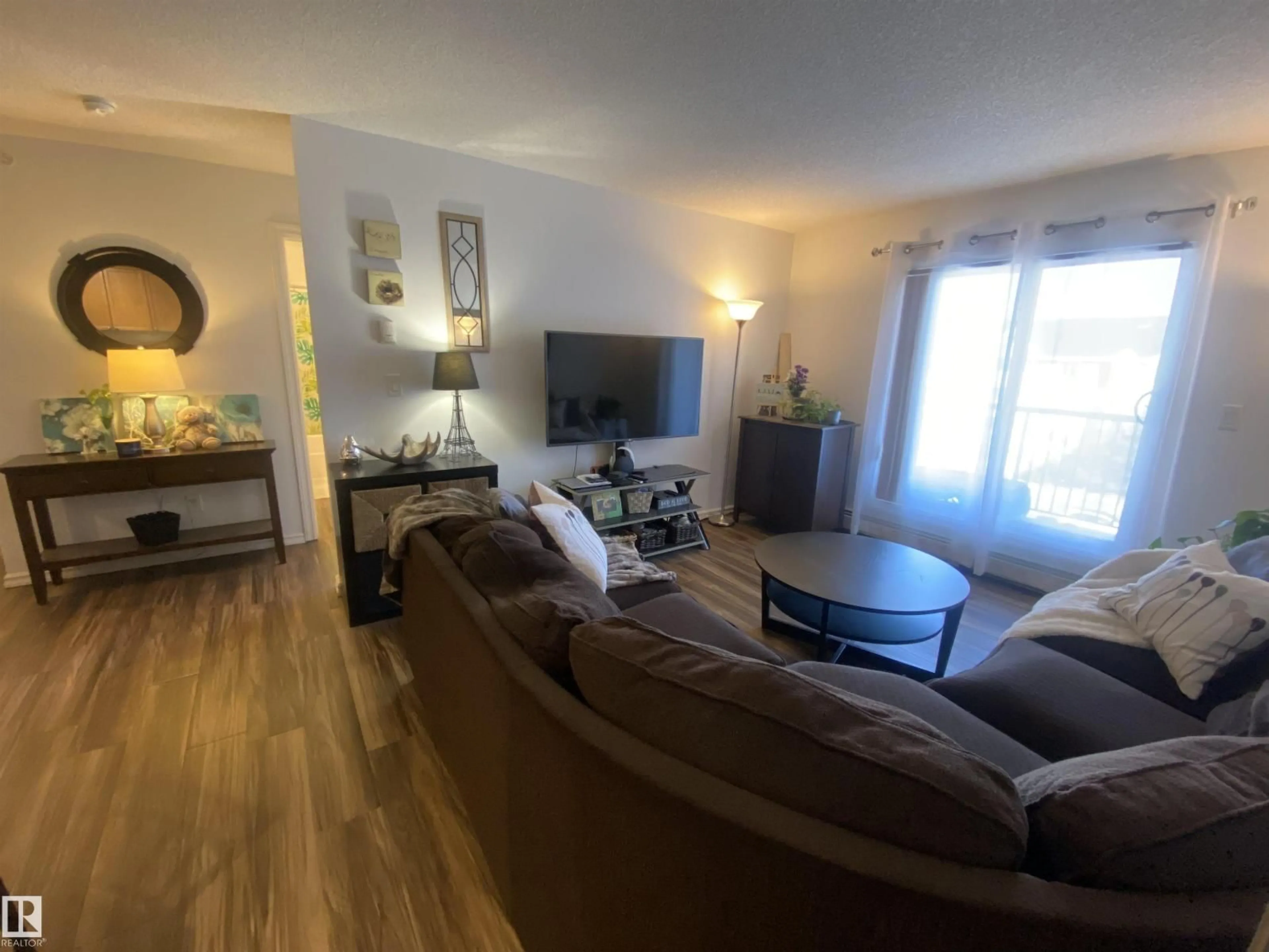 Living room with furniture, wood/laminate floor for 403 - 4403 23 ST, Edmonton Alberta T6T0E4