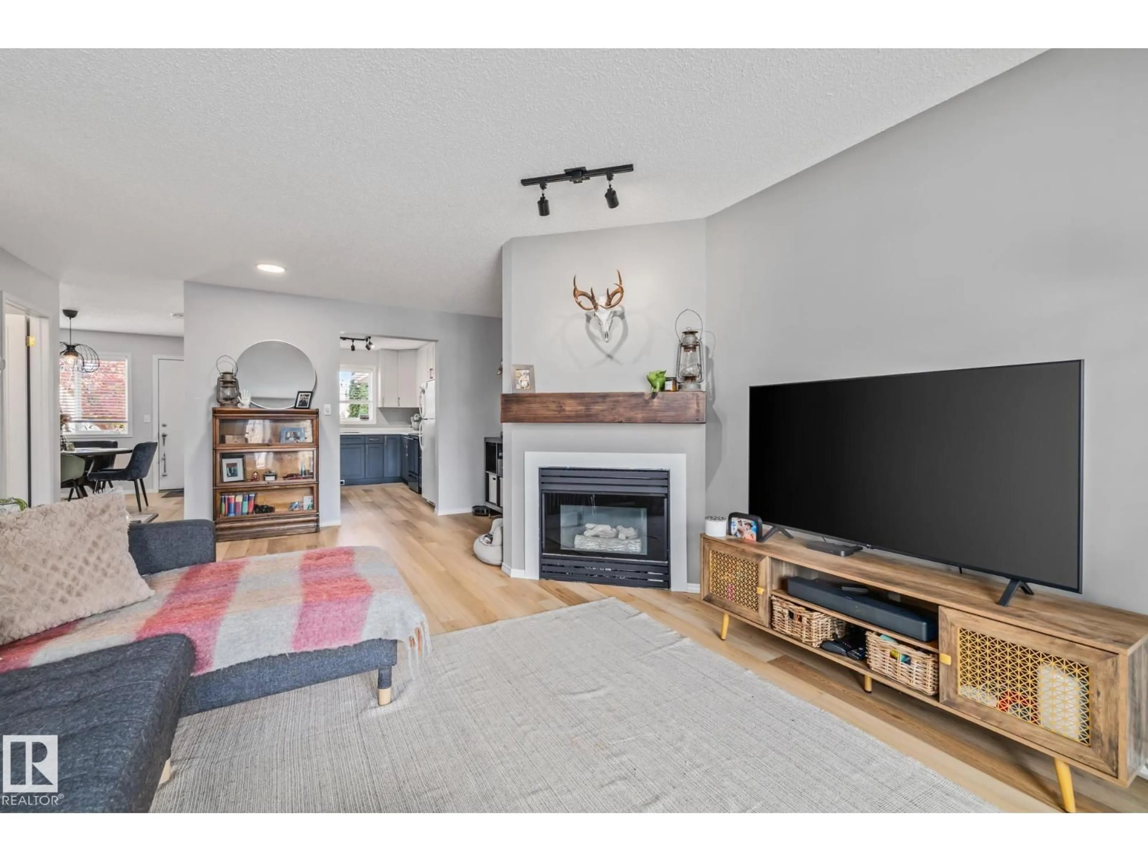 Living room with furniture, wood/laminate floor for 1606 JAMHA RD, Edmonton Alberta T6L6V7