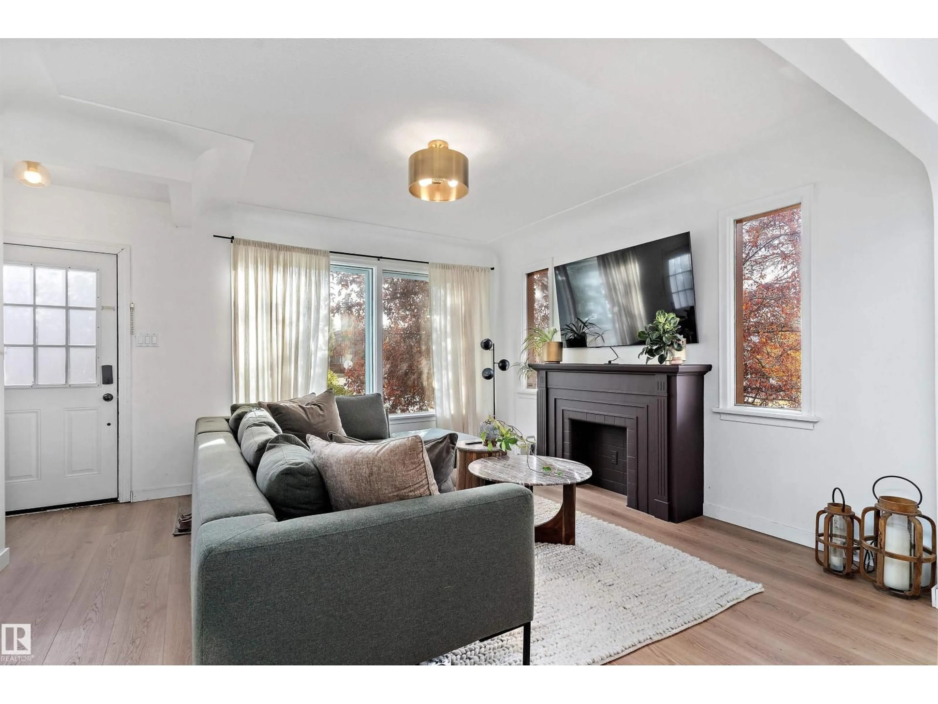 Living room with furniture, wood/laminate floor for 10632 73 AV, Edmonton Alberta T6E1C4