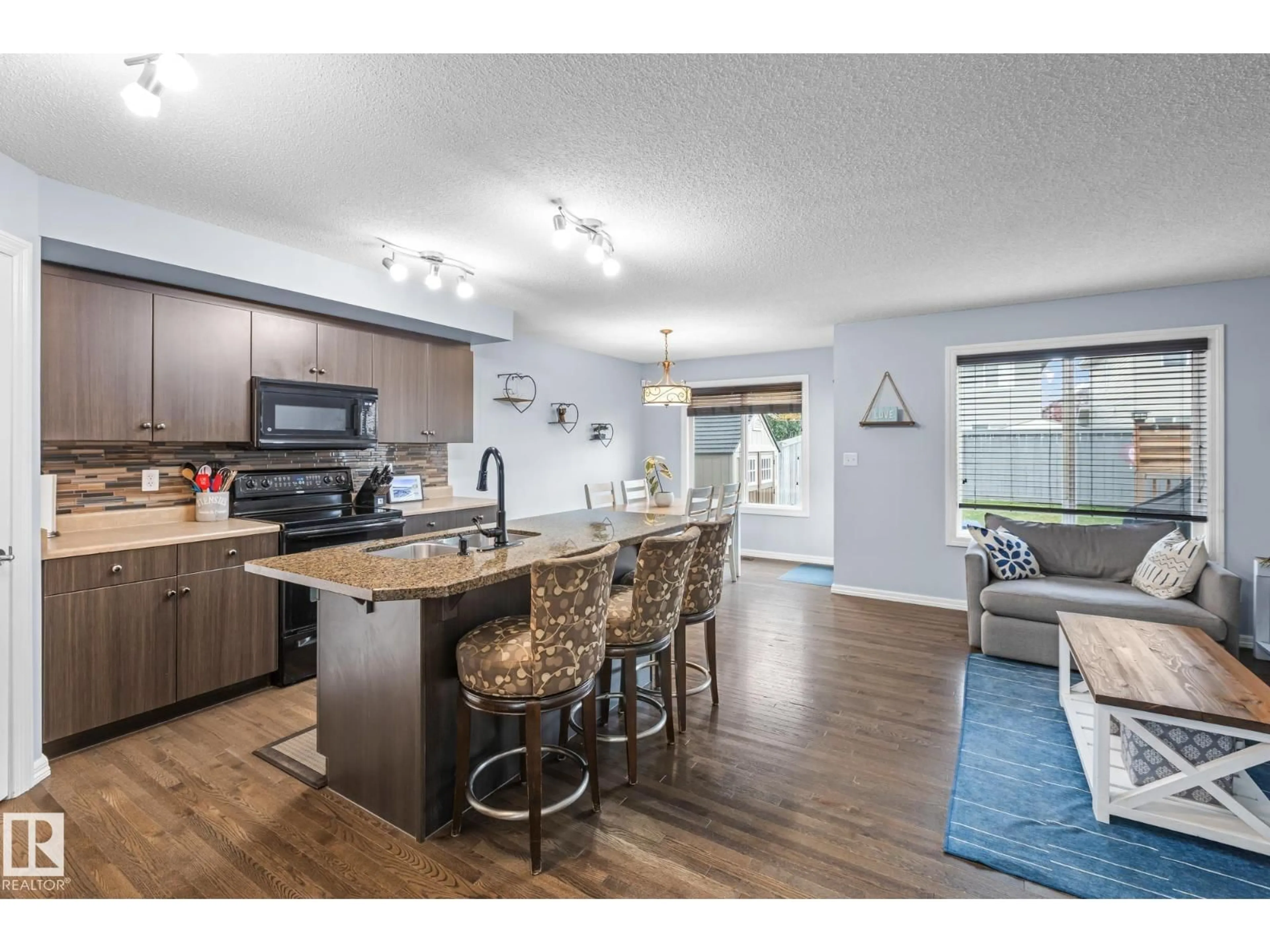 Open concept kitchen, wood/laminate floor for 114 CALVERT WD, Fort Saskatchewan Alberta T8L0C4