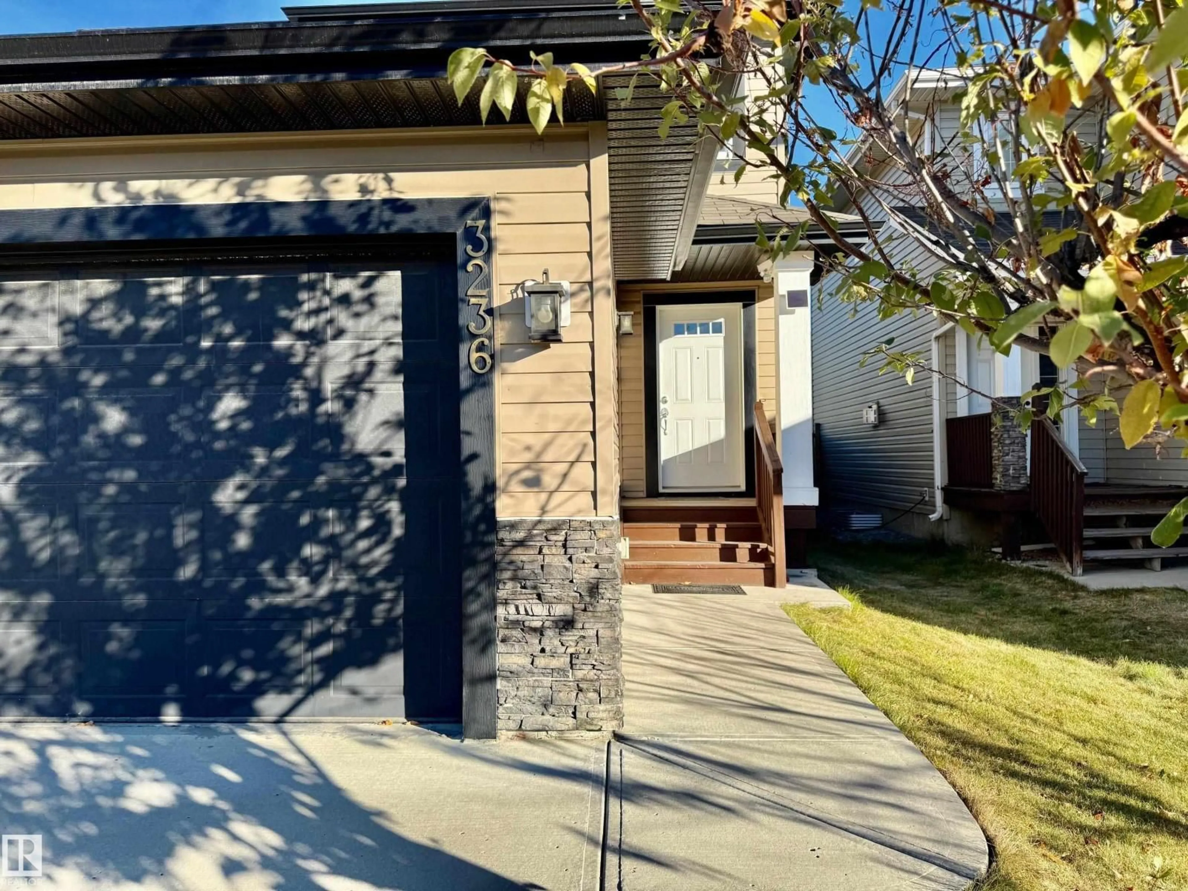 Home with vinyl exterior material, street for NW - 3236 17B AV, Edmonton Alberta T6T0P4