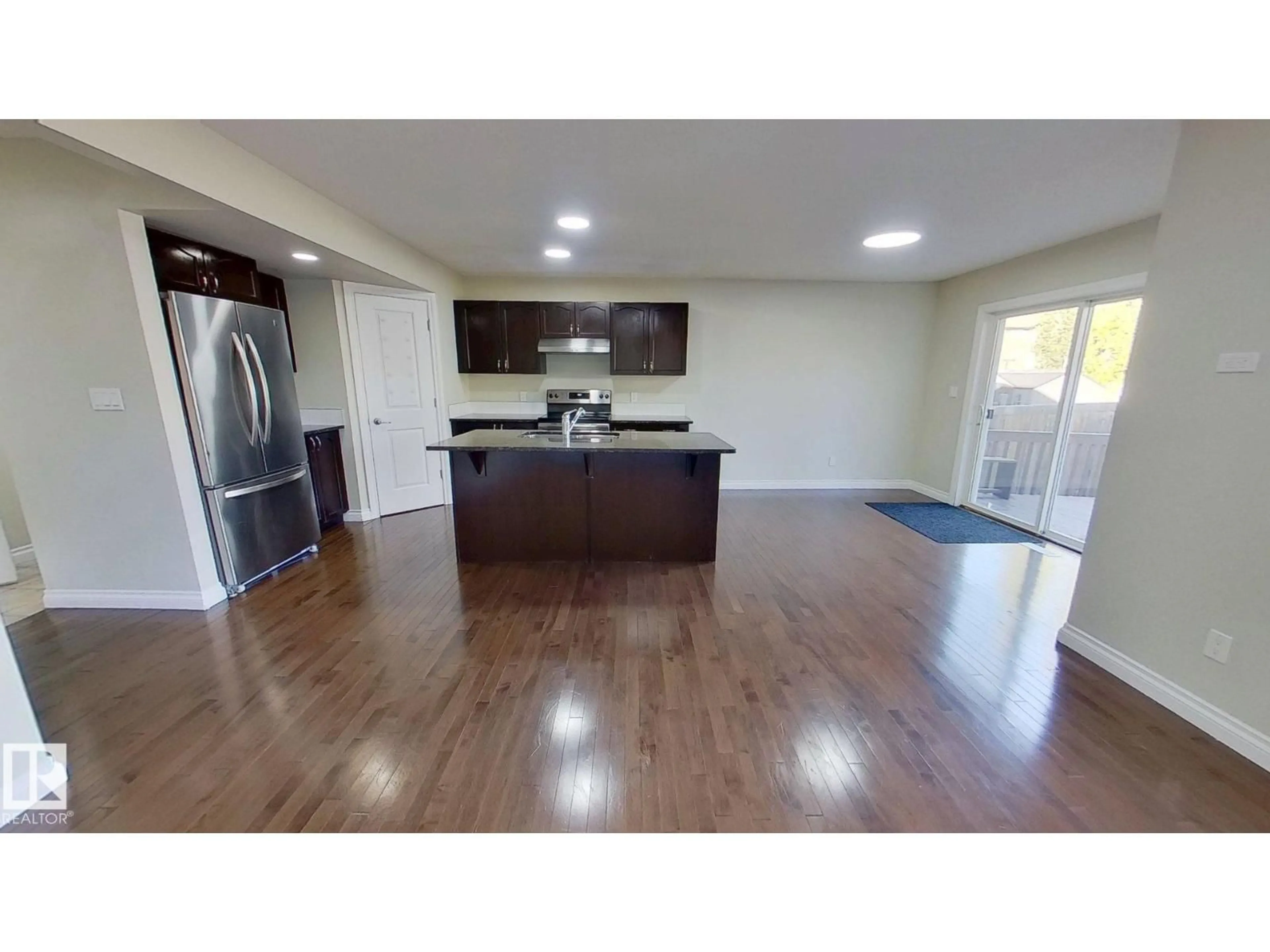 Open concept kitchen, wood/laminate floor for NW - 3236 17B AV, Edmonton Alberta T6T0P4