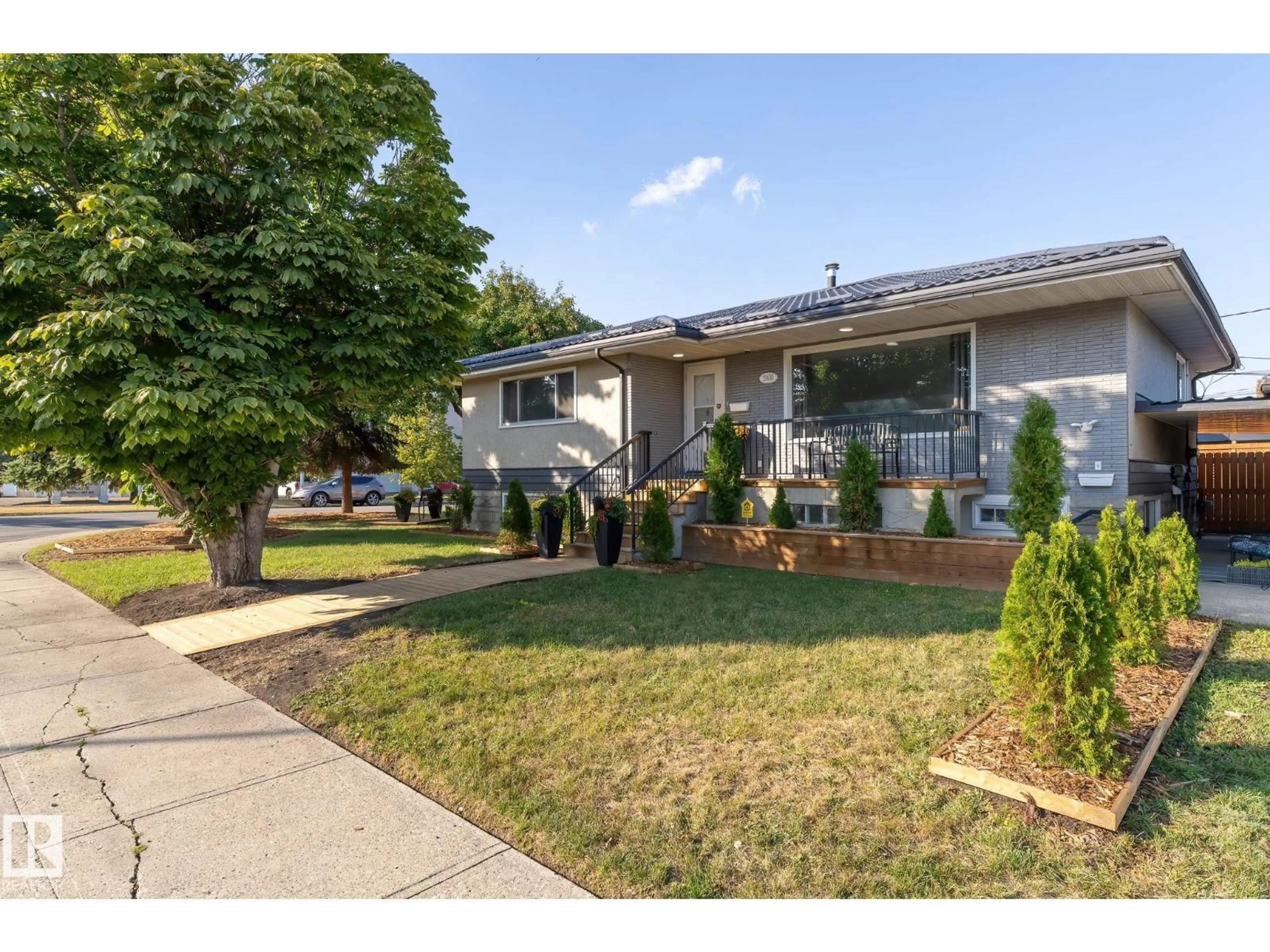 Home with vinyl exterior material, street for 12410 134 AV, Edmonton Alberta T5J3Y4