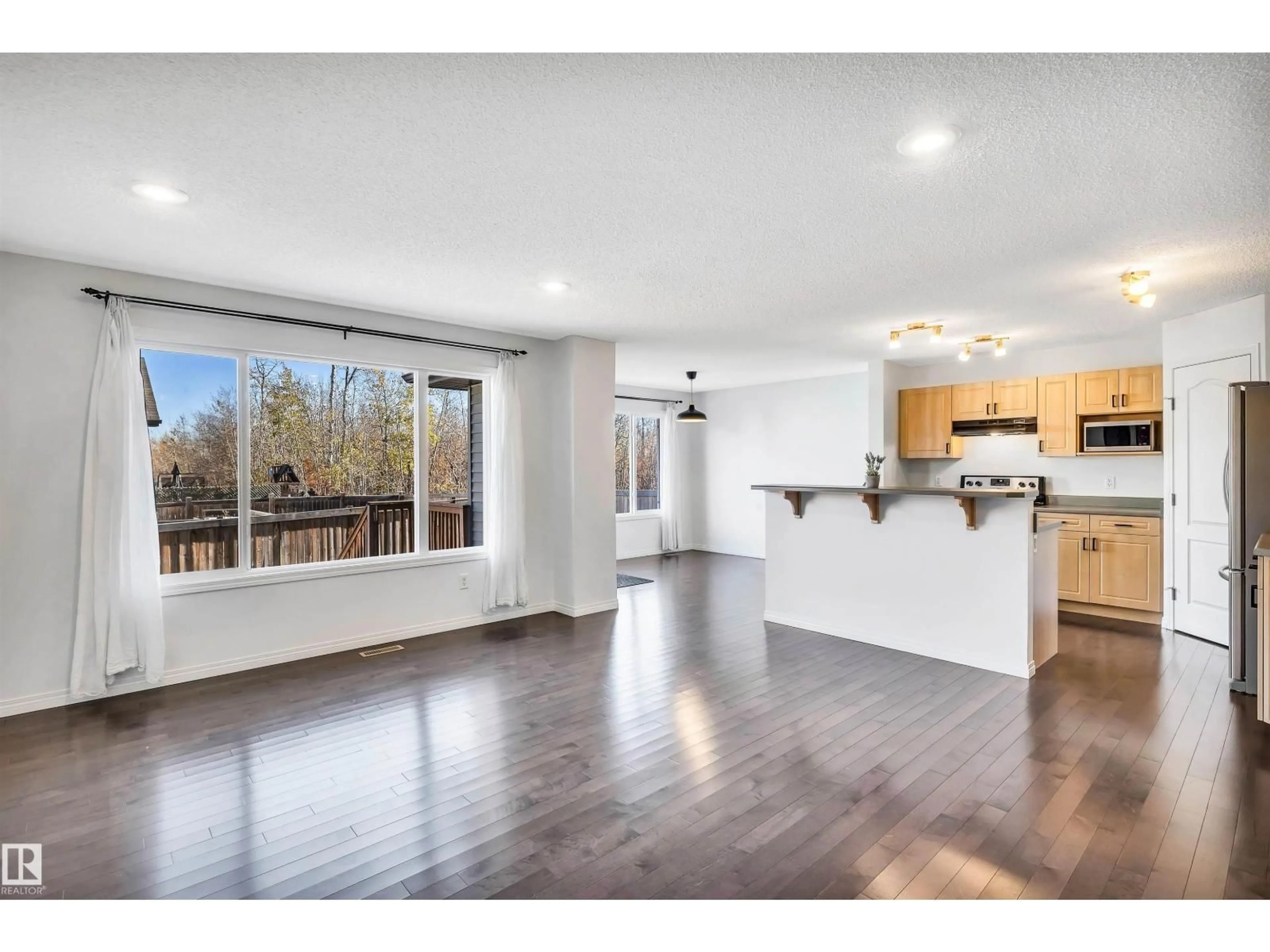 Open concept kitchen, wood/laminate floor for SW - 513 173A ST, Edmonton Alberta T6W2A5