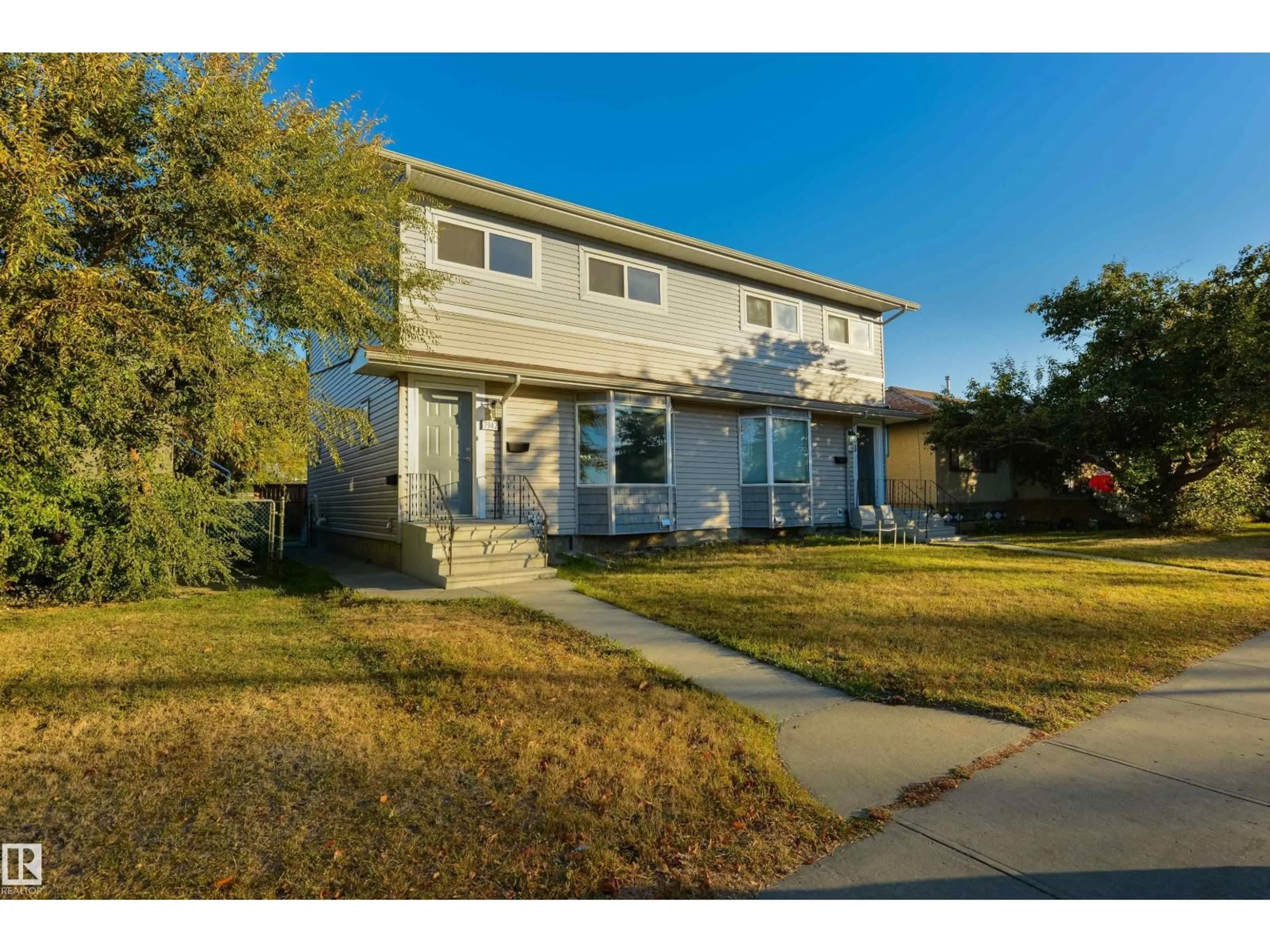 Home with vinyl exterior material, street for 7942 82 AV, Edmonton Alberta T6C0Y2