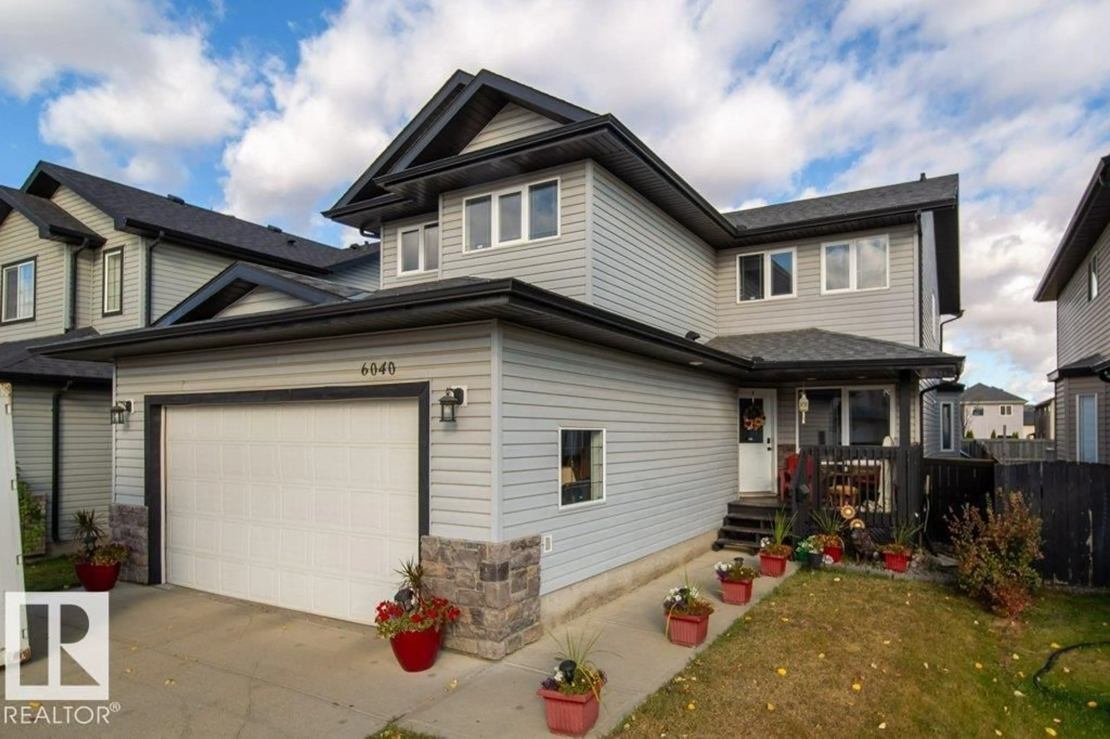 Home with vinyl exterior material, street for 6040 166 AV, Edmonton Alberta T5Y0A8