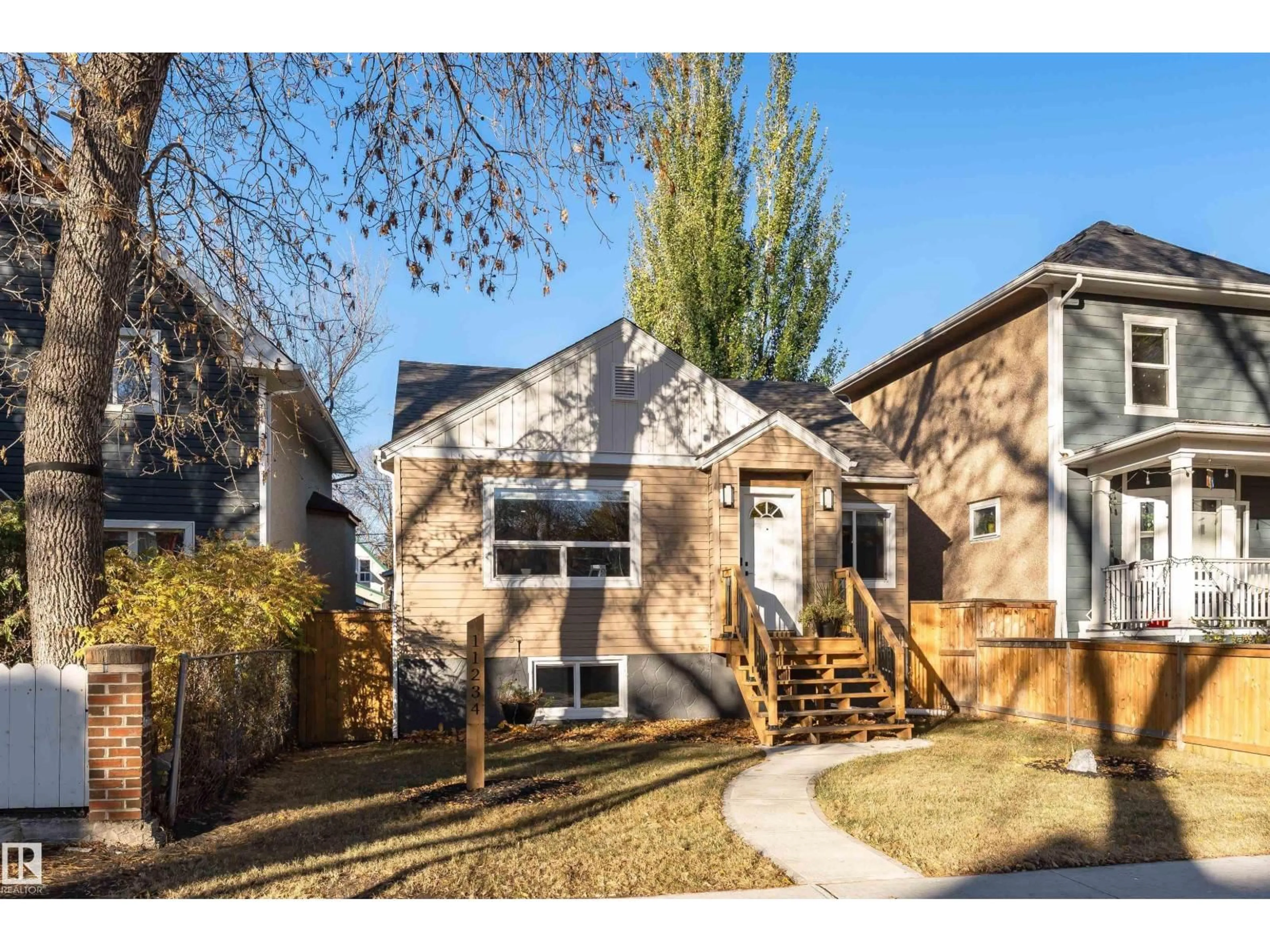 Home with vinyl exterior material, street for NW - 11234 91 ST, Edmonton Alberta T5B4A2