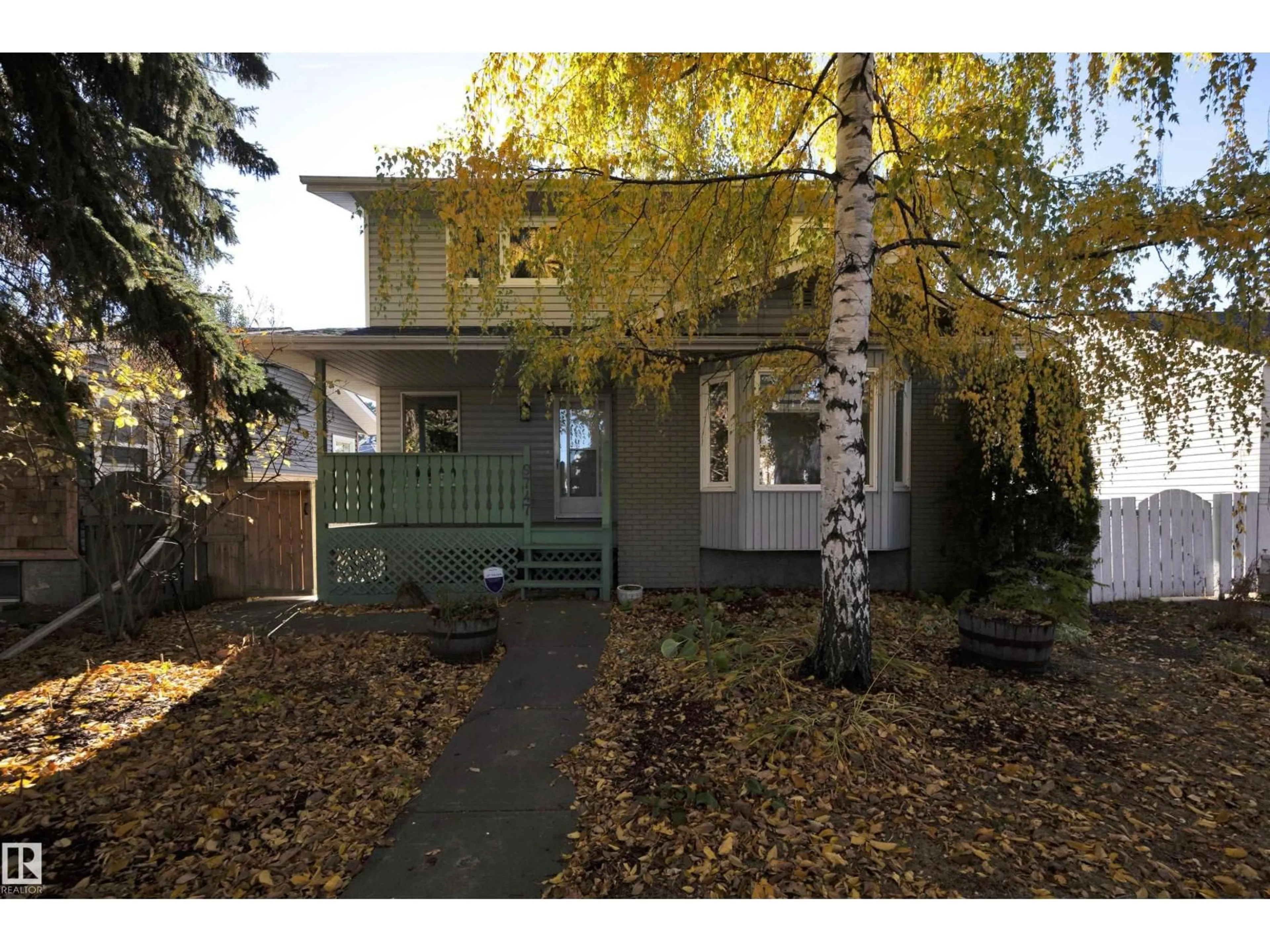 Home with vinyl exterior material, street for 9747 81 AV, Edmonton Alberta T6E1W1