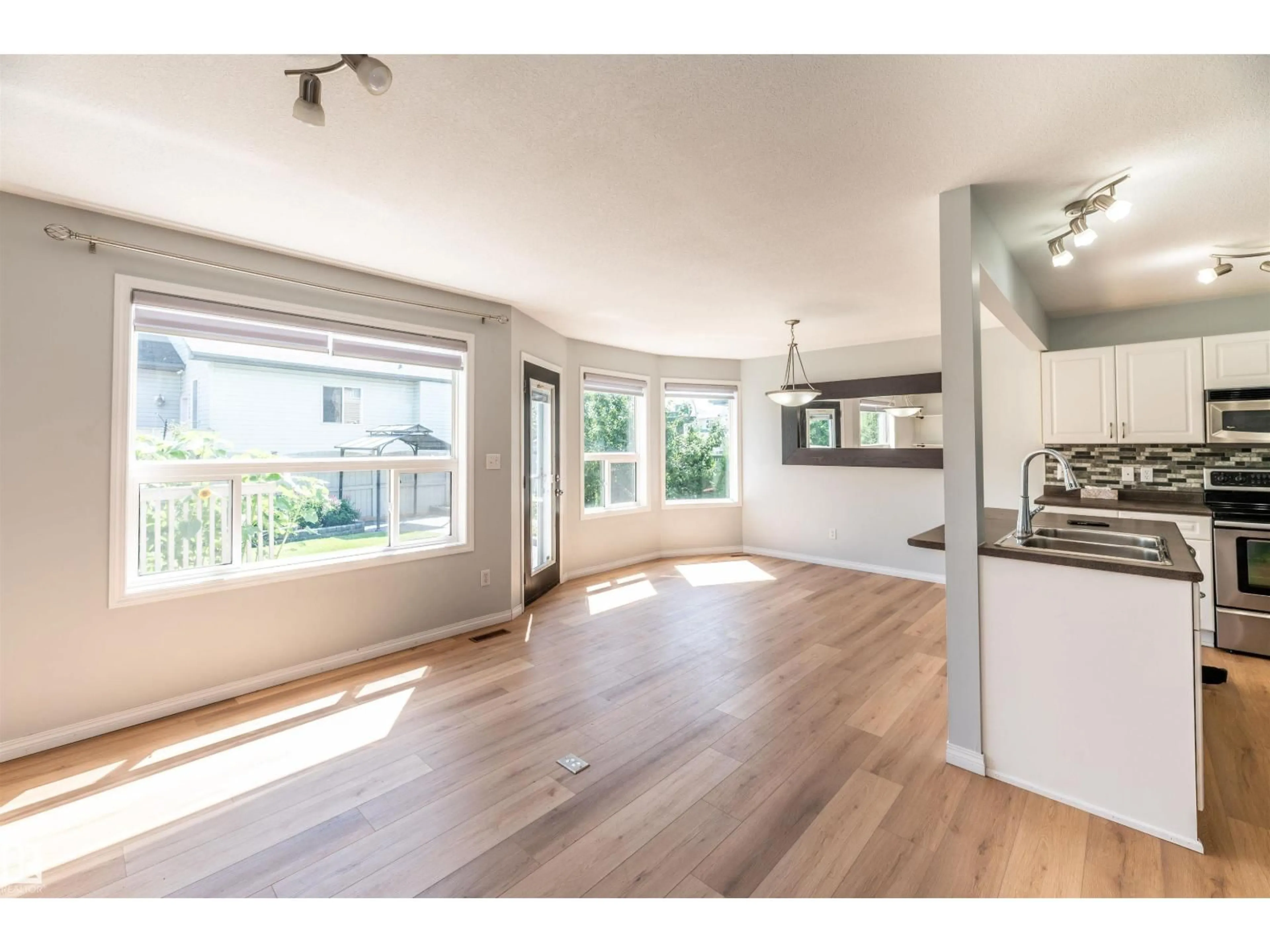 Open concept kitchen, wood/laminate floor for 3729 138A AV, Edmonton Alberta T5Y3G6