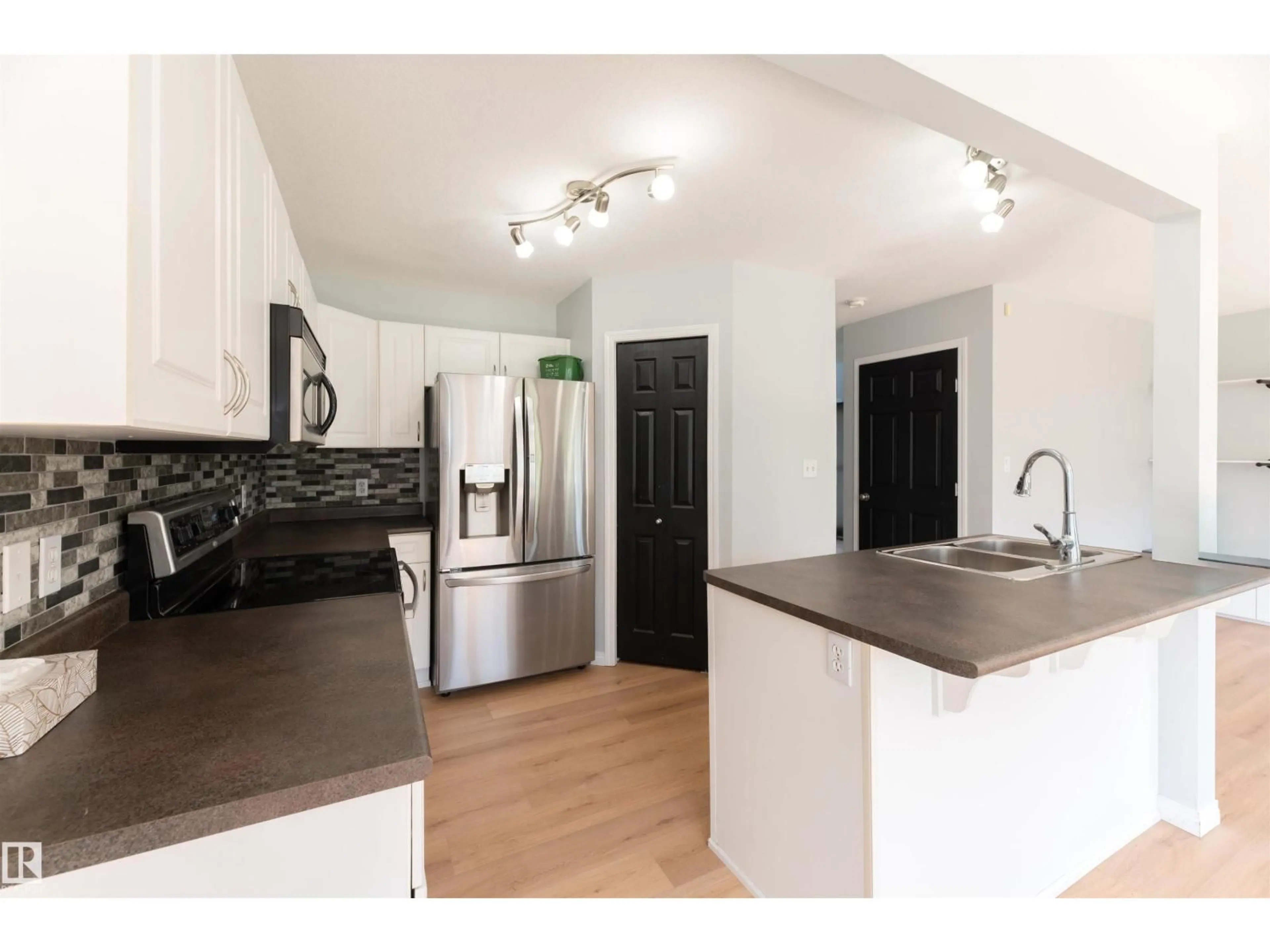 Open concept kitchen, wood/laminate floor for 3729 138A AV, Edmonton Alberta T5Y3G6