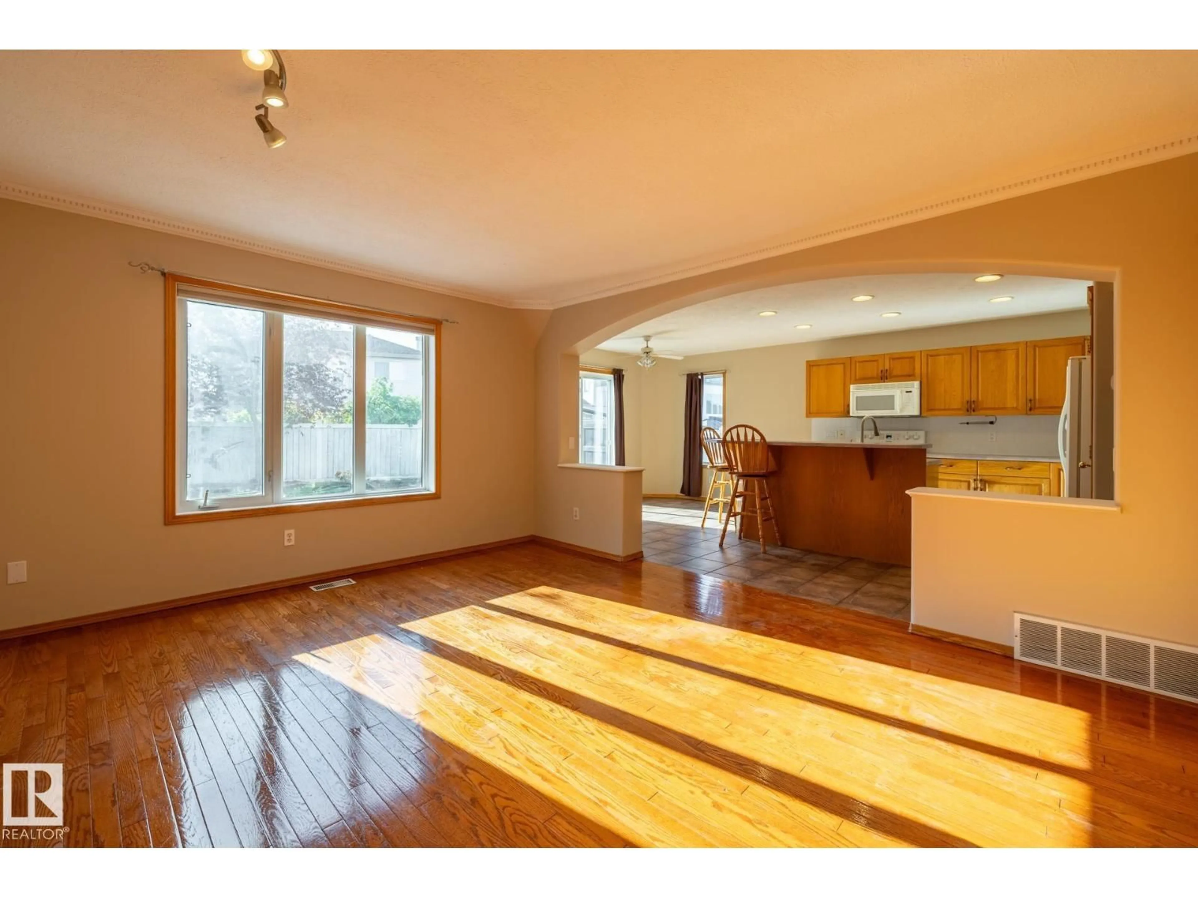 Open concept kitchen, wood/laminate floor for NW - 9813 180 AV, Edmonton Alberta T5X6A1