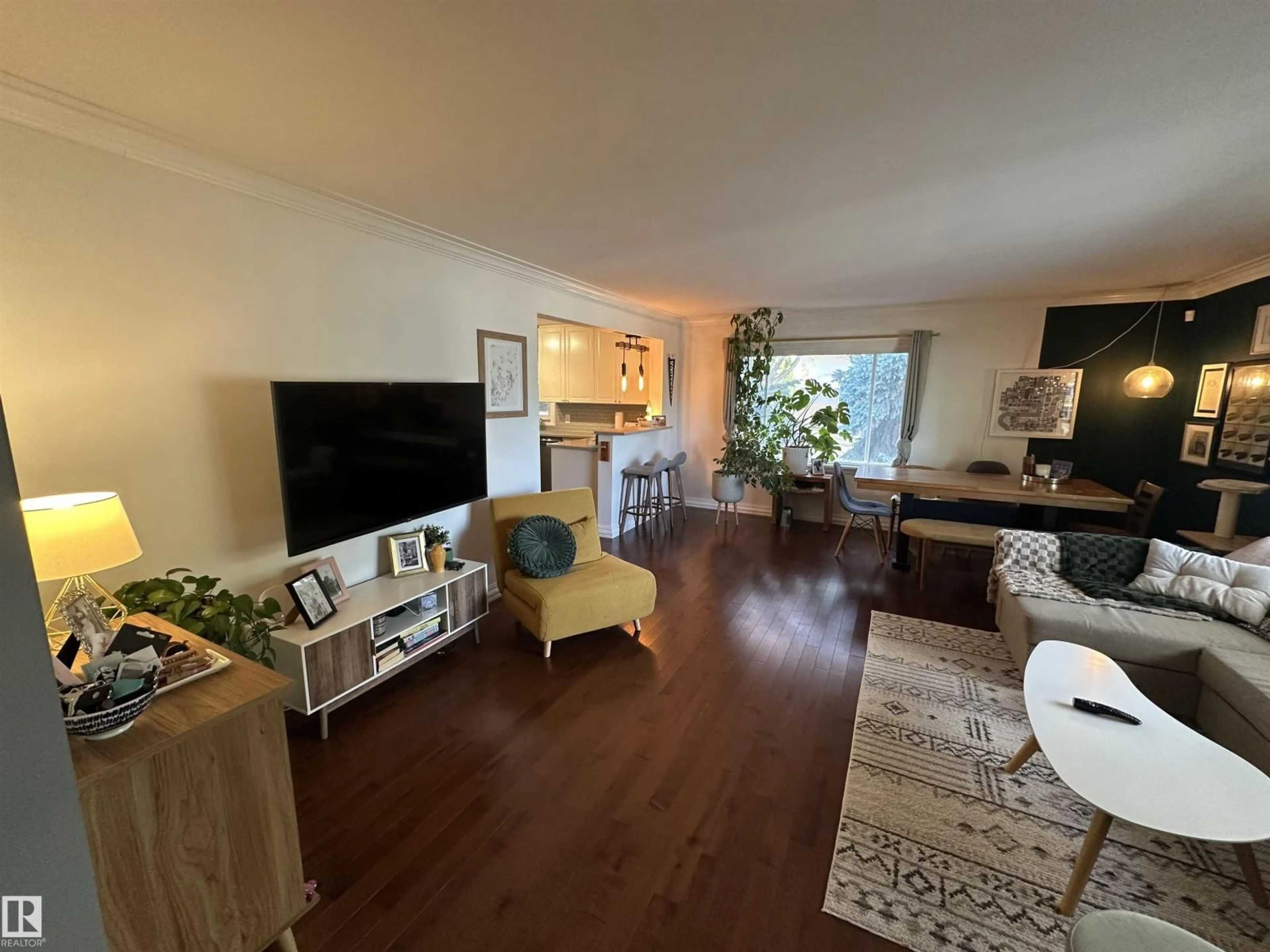 Living room with furniture, wood/laminate floor for 10447 81 ST, Edmonton Alberta T6A3K9
