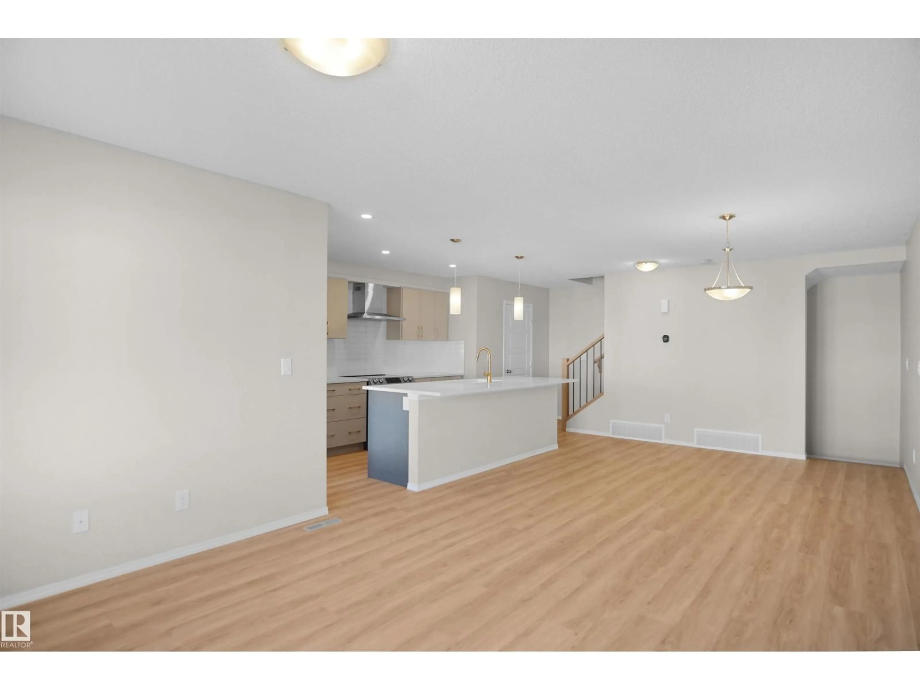 Open concept kitchen, wood/laminate floor for NW - 20525 21A AV, Edmonton Alberta T6M1N1