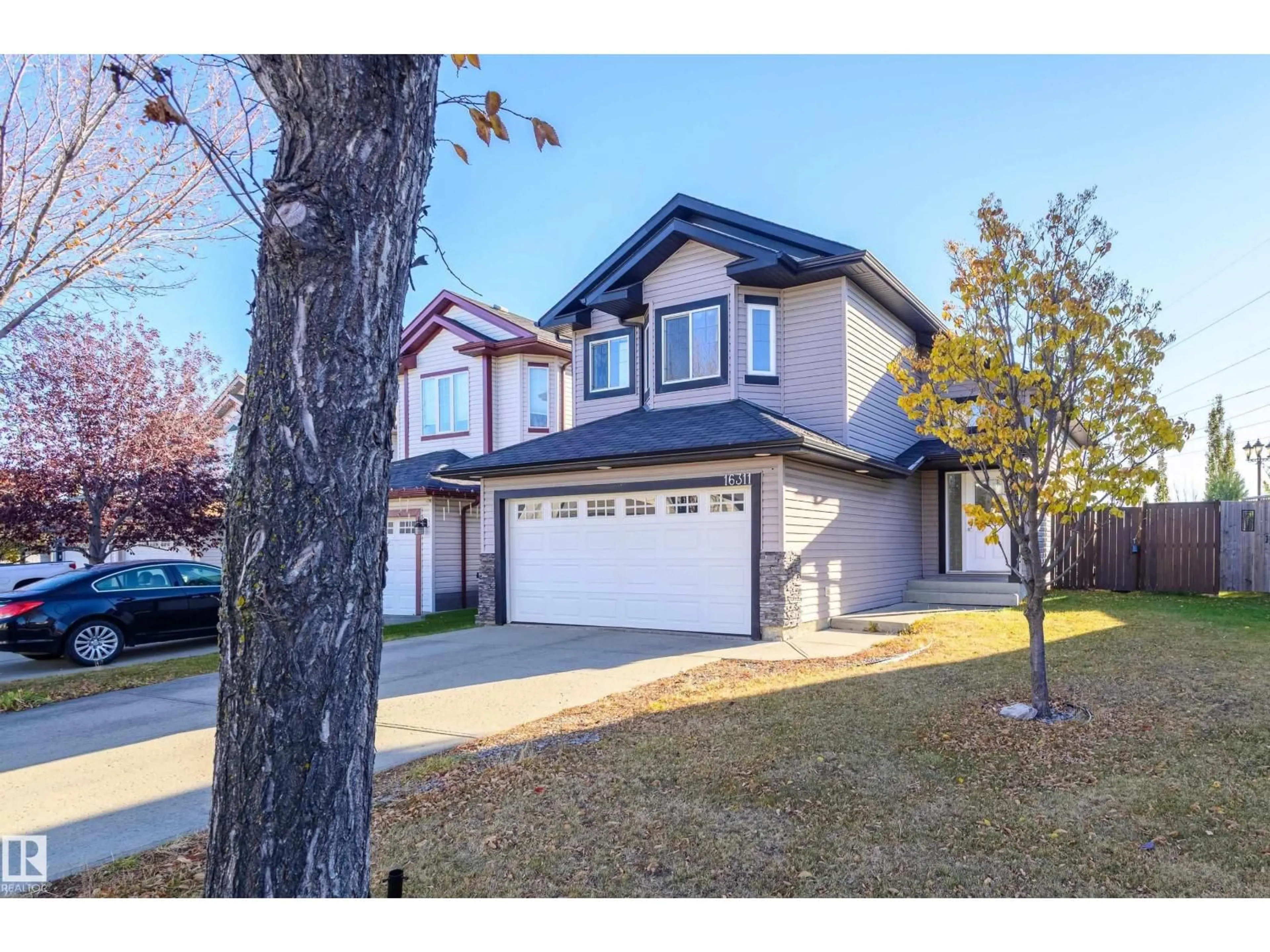 Home with vinyl exterior material, street for 16311 55 ST, Edmonton Alberta T5Y3K9