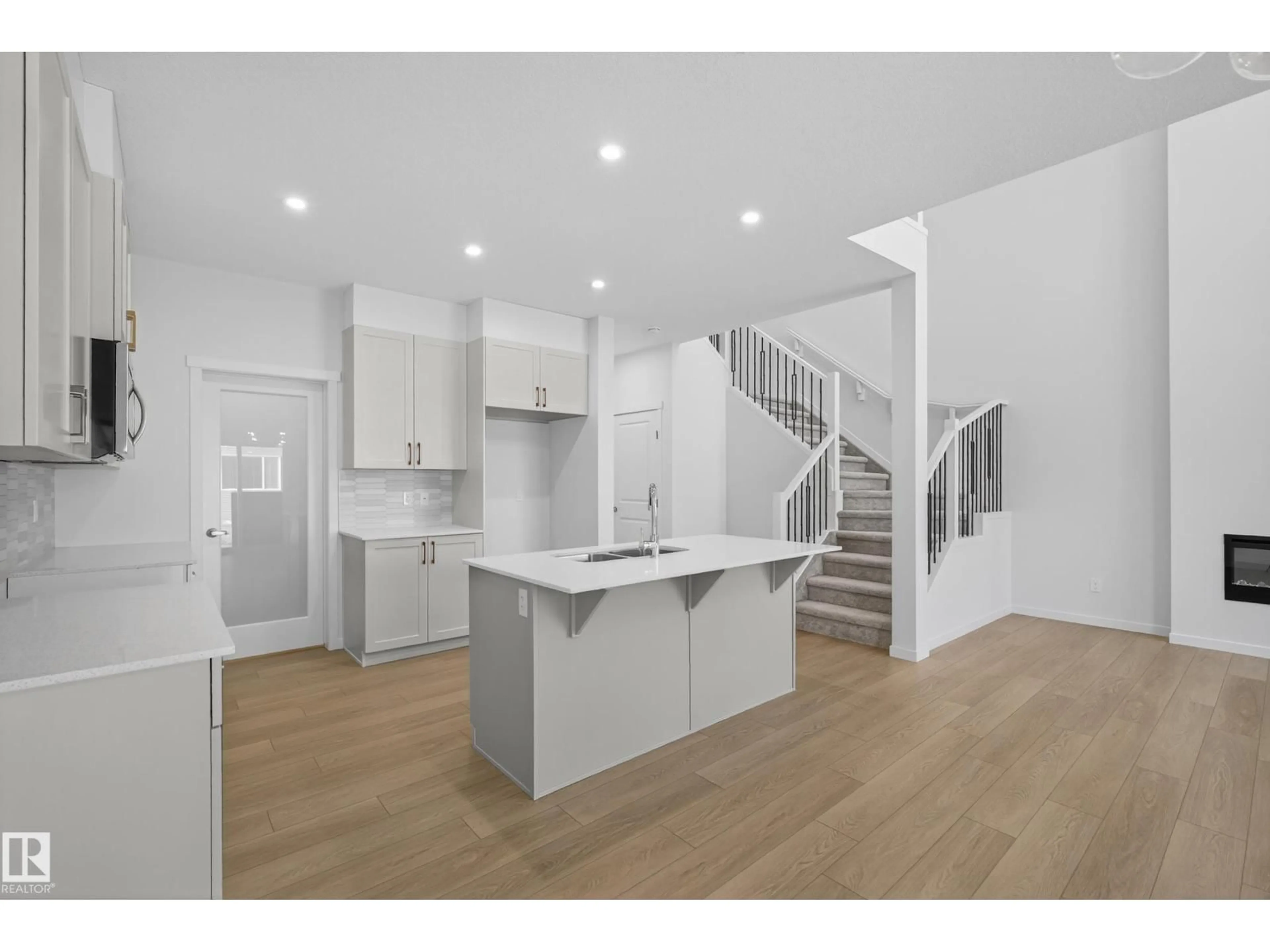Open concept kitchen, wood/laminate floor for NW - 2153 194A ST, Edmonton Alberta T6M3J3