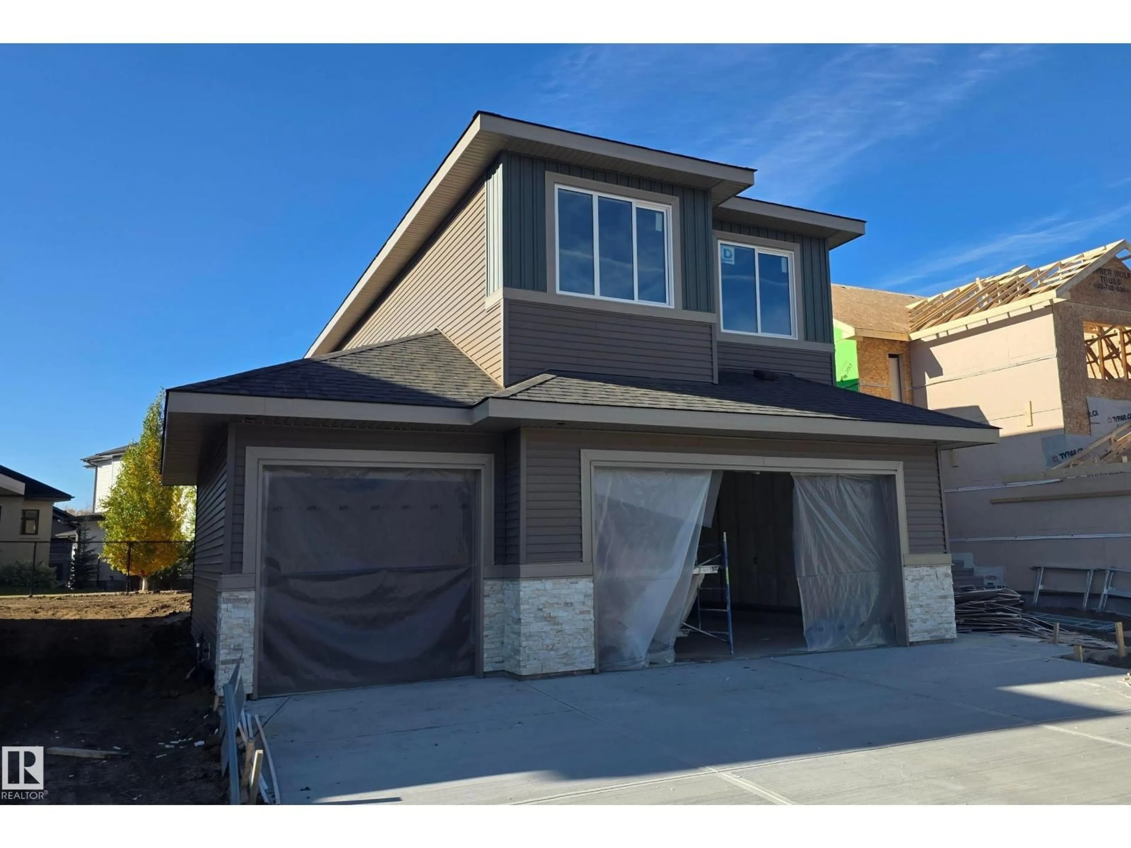 Home with vinyl exterior material, street for 219 RAVINE DR, Devon Alberta T9G0M2