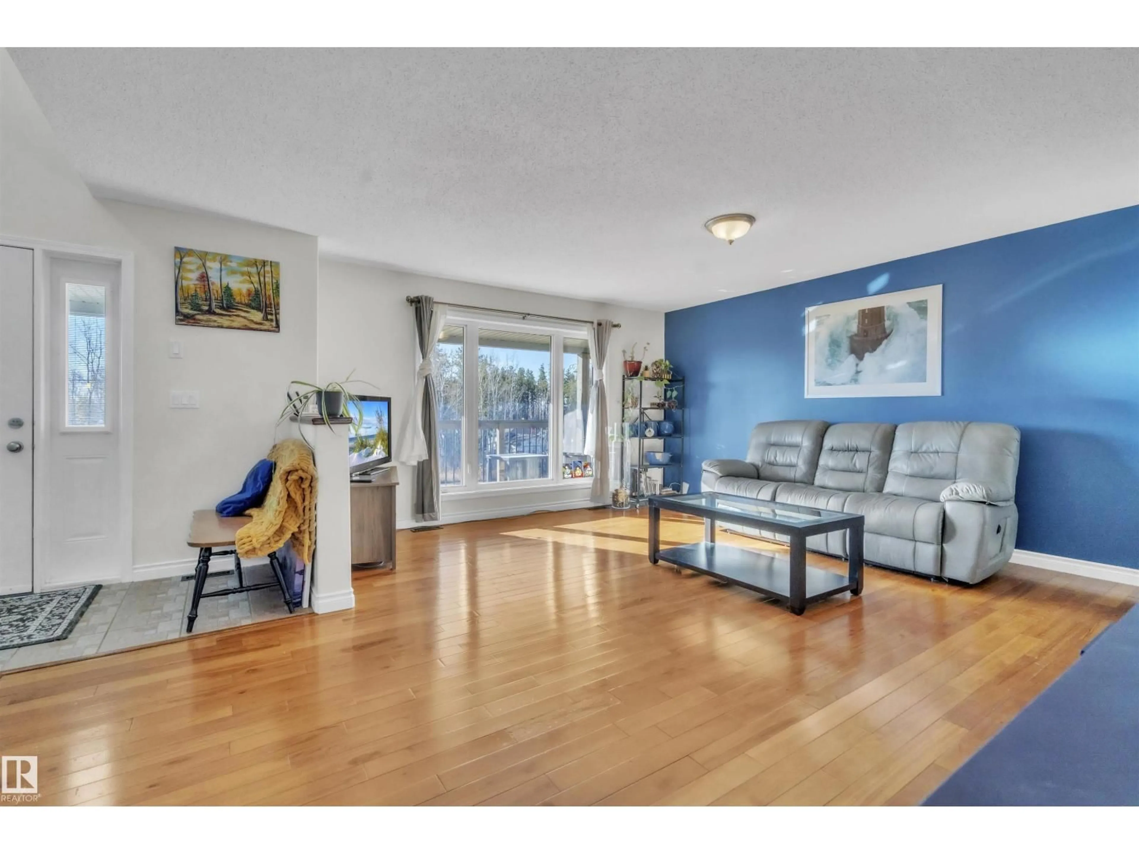 Living room with furniture, wood/laminate floor for 5003 52 AV, Rural Bonnyville M.D. Alberta T0A0T0