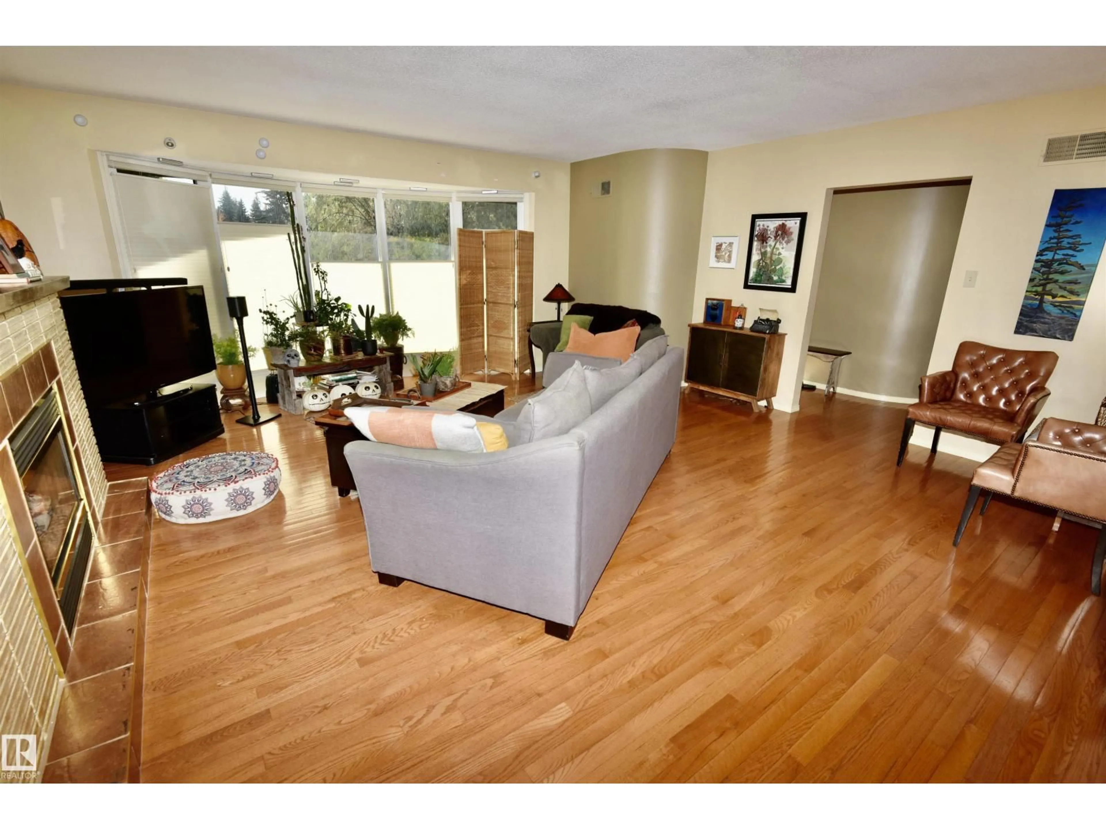Living room with furniture, wood/laminate floor for NW - 13910 101A AV, Edmonton Alberta T5N0L2