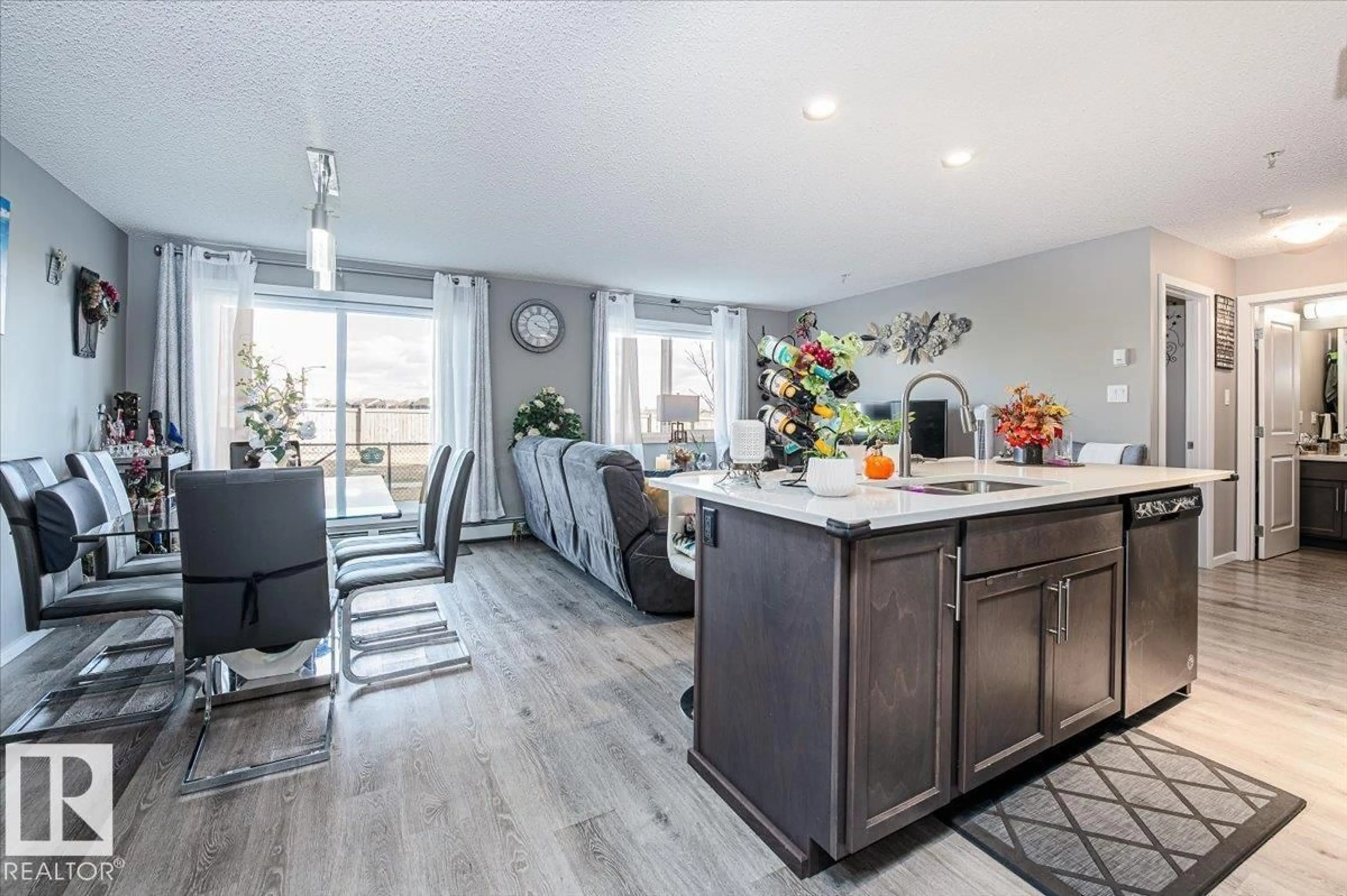 Open concept kitchen, wood/laminate floor for 148 - 129 EBBERS BV, Edmonton Alberta T5Y4A4