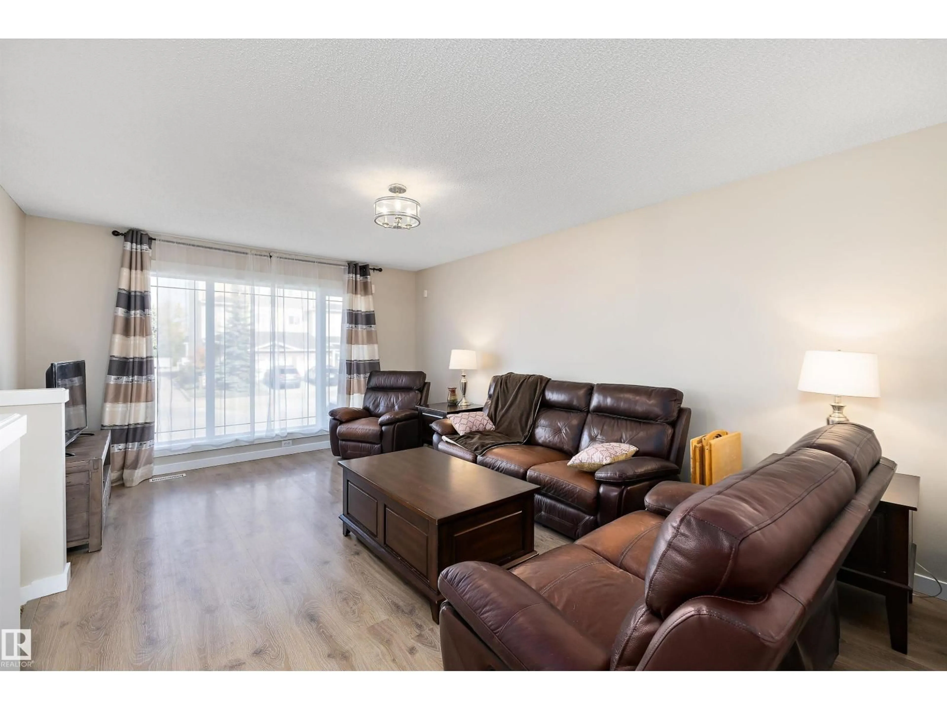 Living room with furniture, wood/laminate floor for 3019 33 AV, Edmonton Alberta T6T1X2