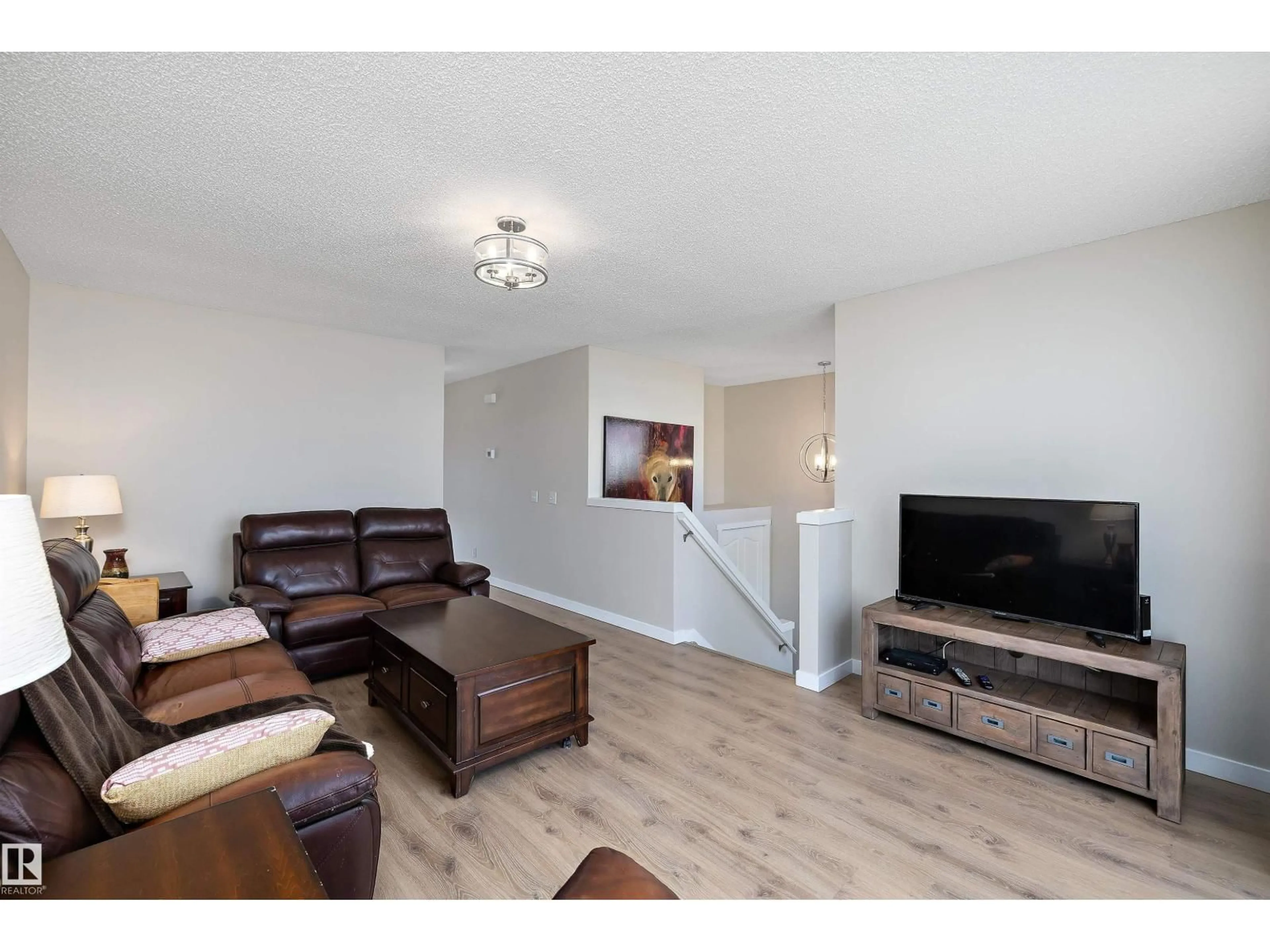 Living room with furniture, wood/laminate floor for 3019 33 AV, Edmonton Alberta T6T1X2