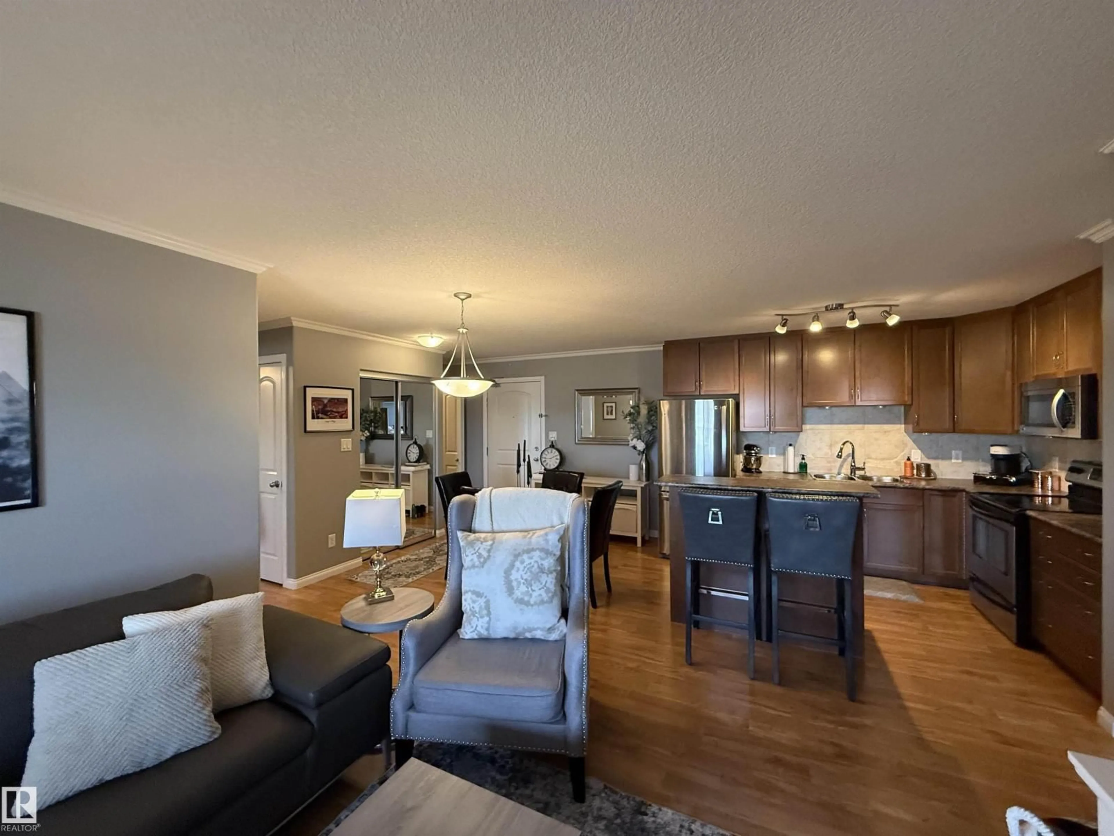 Living room with furniture, wood/laminate floor for 415 - 1204 156 ST, Edmonton Alberta T6R0R6