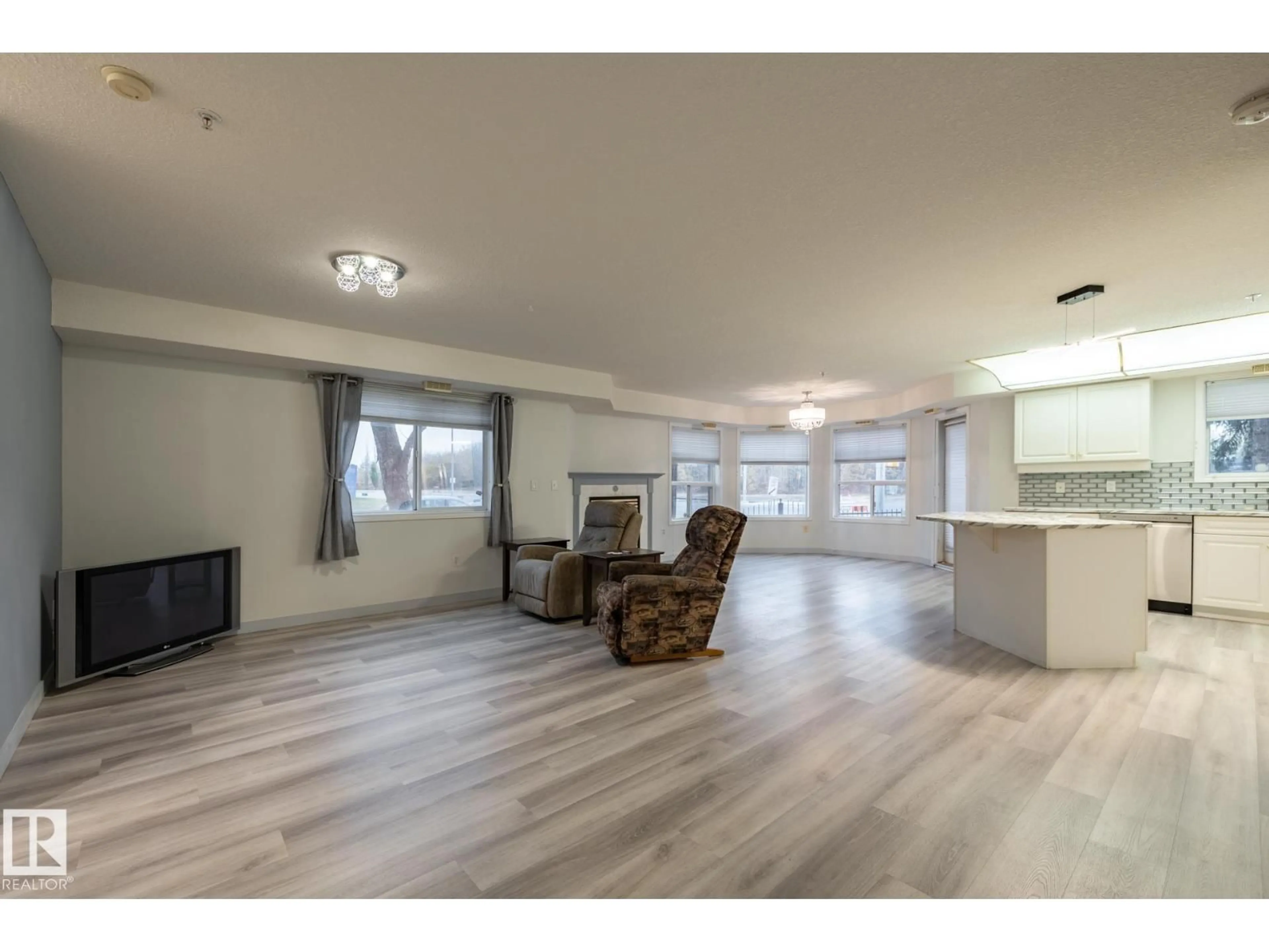 Living room with furniture, wood/laminate floor for #106 - 6703 172 ST, Edmonton Alberta T5T6H9