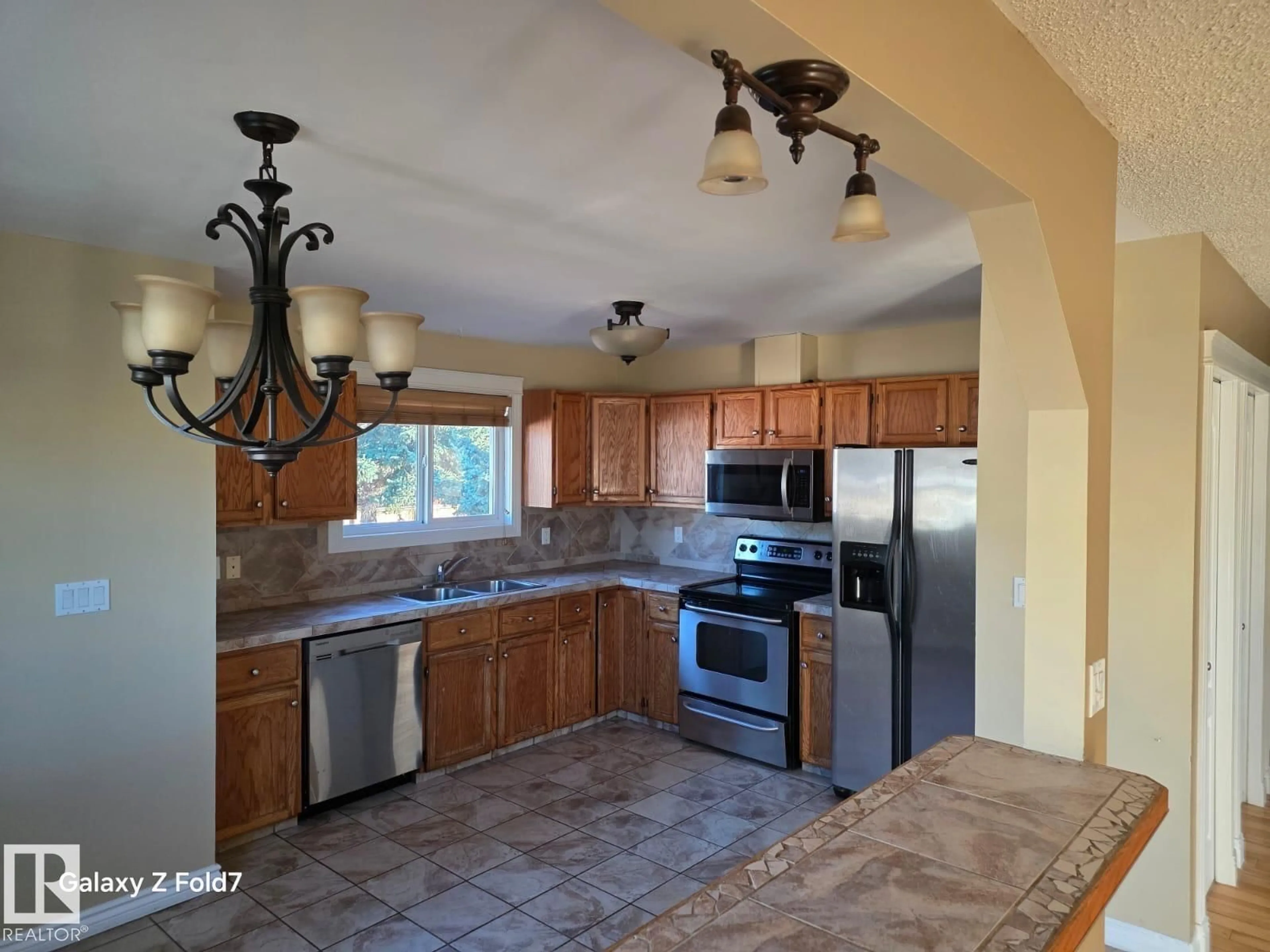 Open concept kitchen, ceramic/tile floor for 3428 143 AV, Edmonton Alberta T5Y1H7