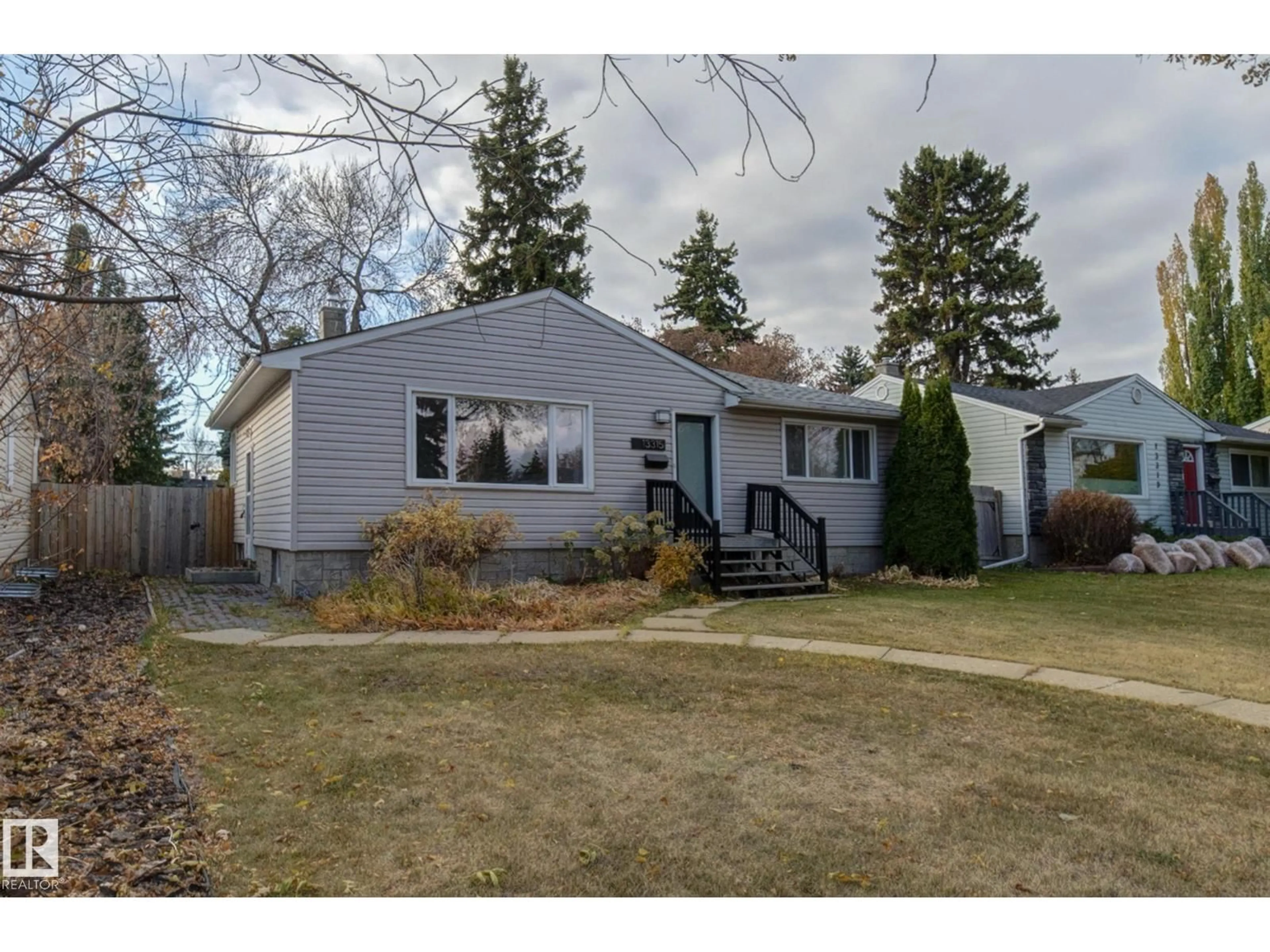 Home with vinyl exterior material, street for 13315 110 AV, Edmonton Alberta T5M2M1