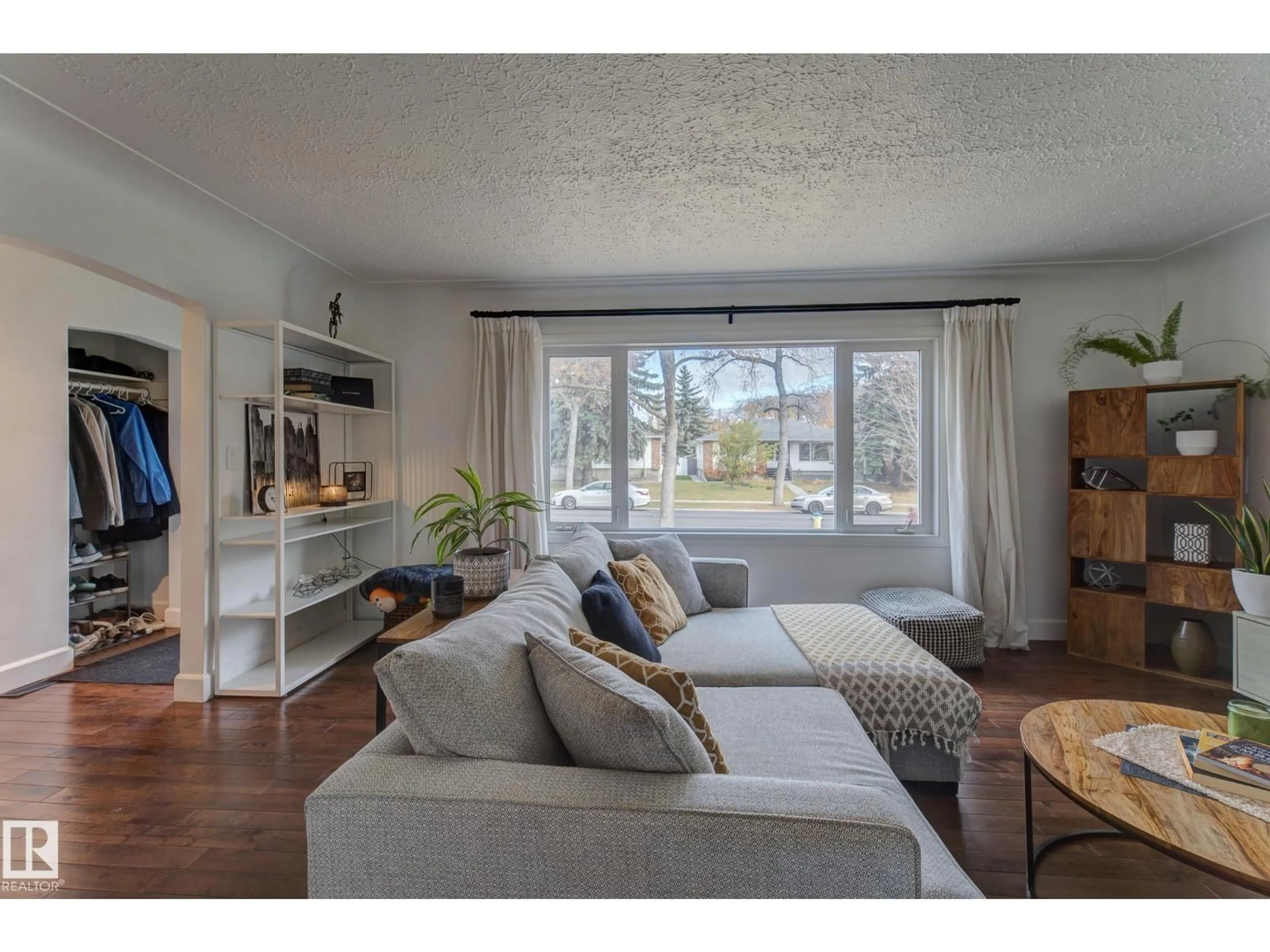 Living room with furniture, wood/laminate floor for 13315 110 AV, Edmonton Alberta T5M2M1