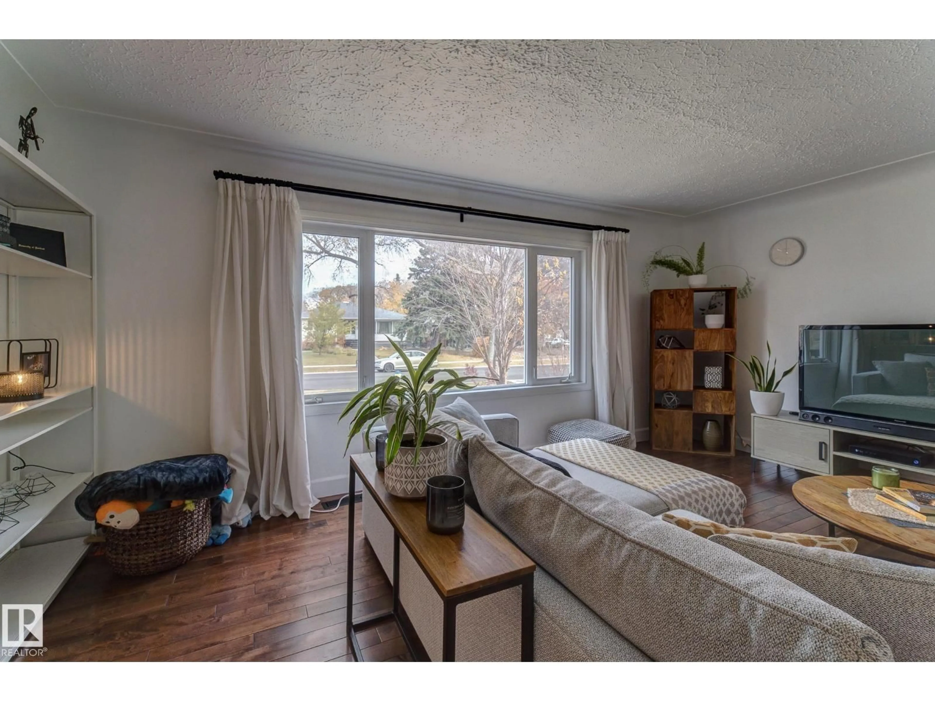 Living room with furniture, wood/laminate floor for 13315 110 AV, Edmonton Alberta T5M2M1