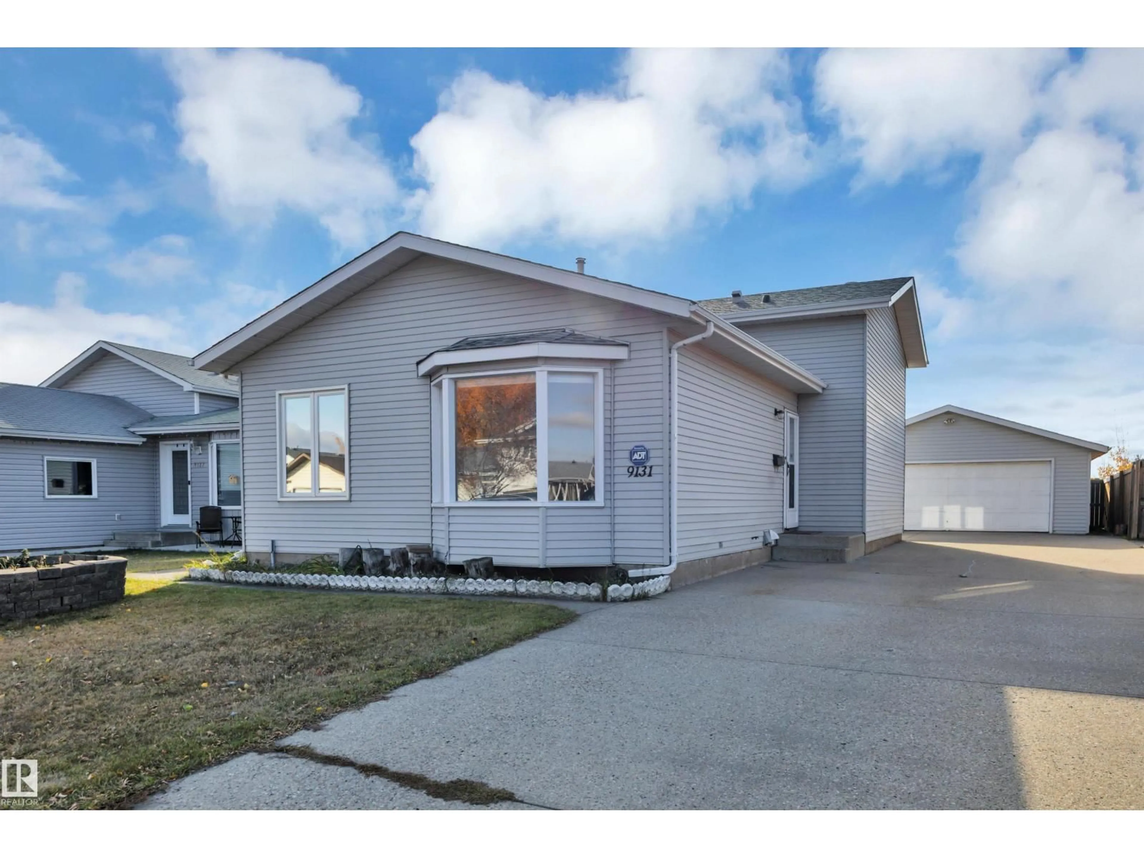 Home with vinyl exterior material, street for 9131 175 AV, Edmonton Alberta T5Z2M3