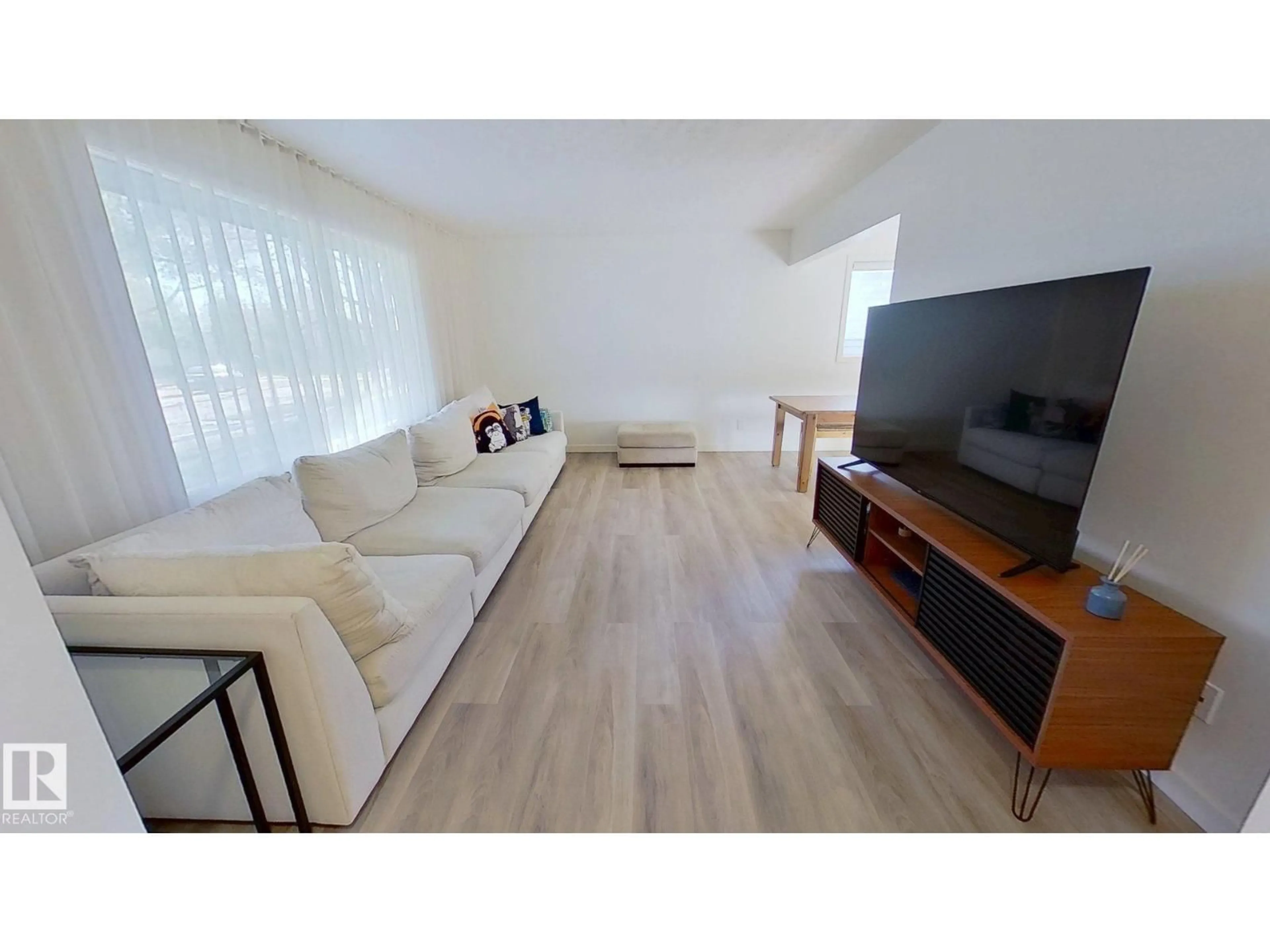 Living room with furniture, wood/laminate floor for 16466 104A AV, Edmonton Alberta T5P0T4