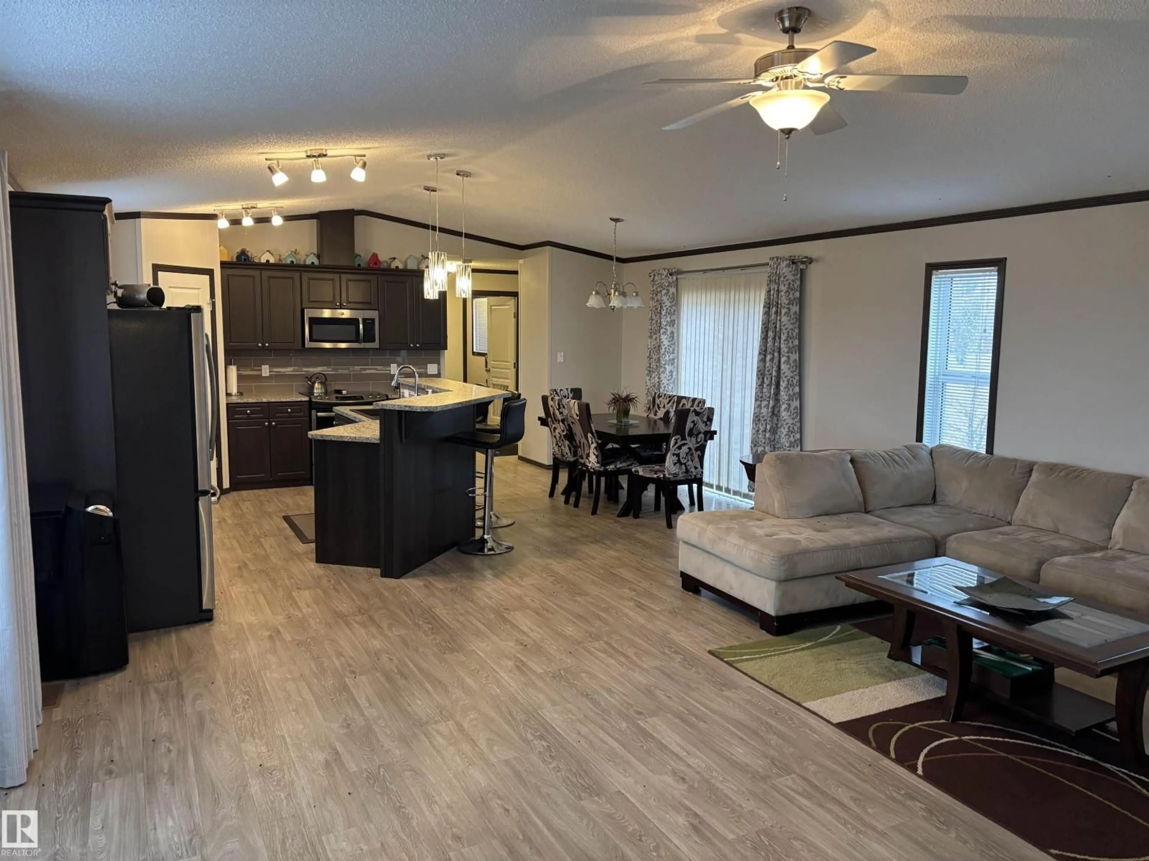 Open concept kitchen, wood/laminate floor for 1602 PARAKEET CL, Rural Camrose County Alberta T0B4J1