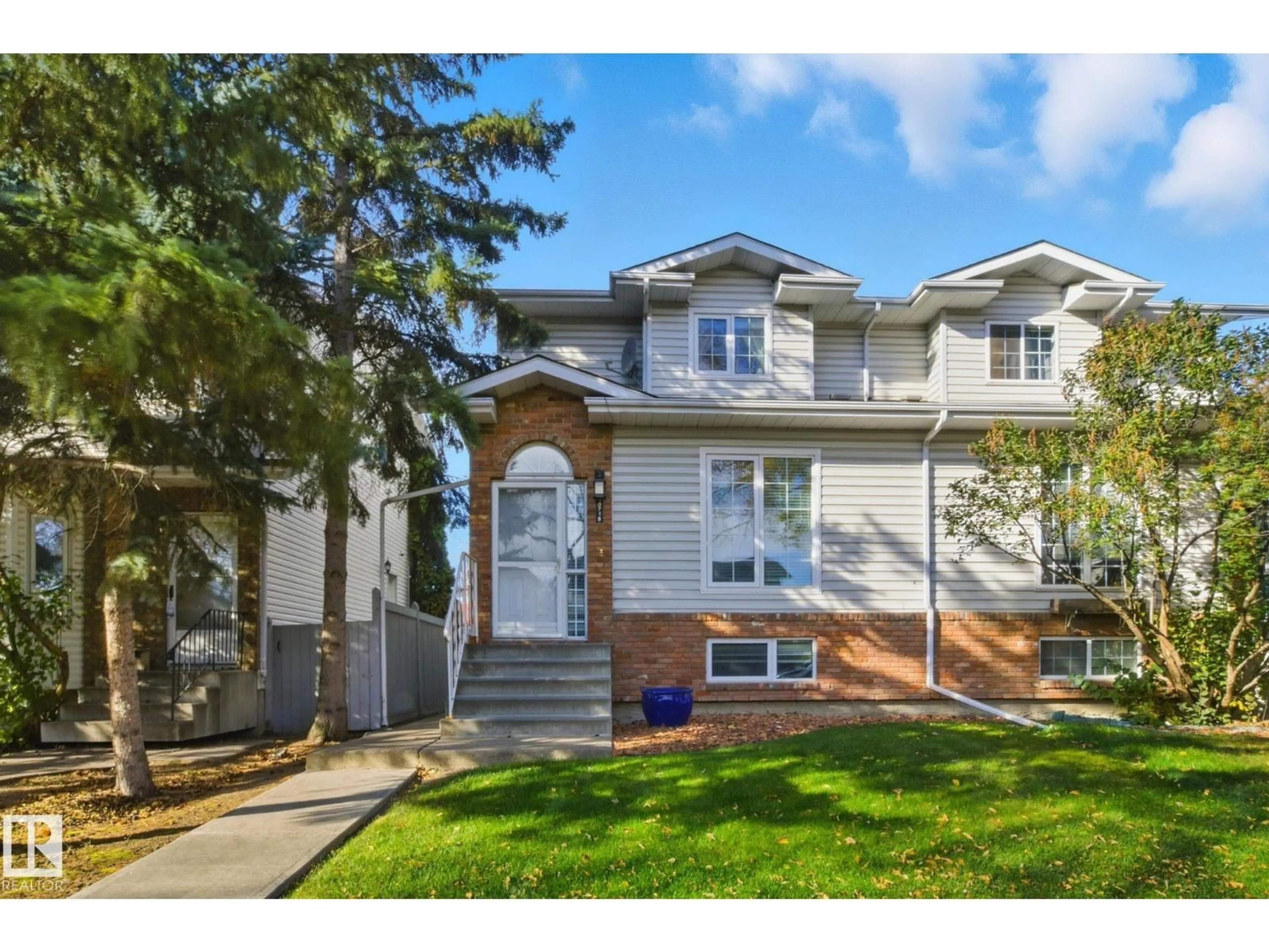 Home with vinyl exterior material, street for NW - 10718 122 ST, Edmonton Alberta T5M0A3