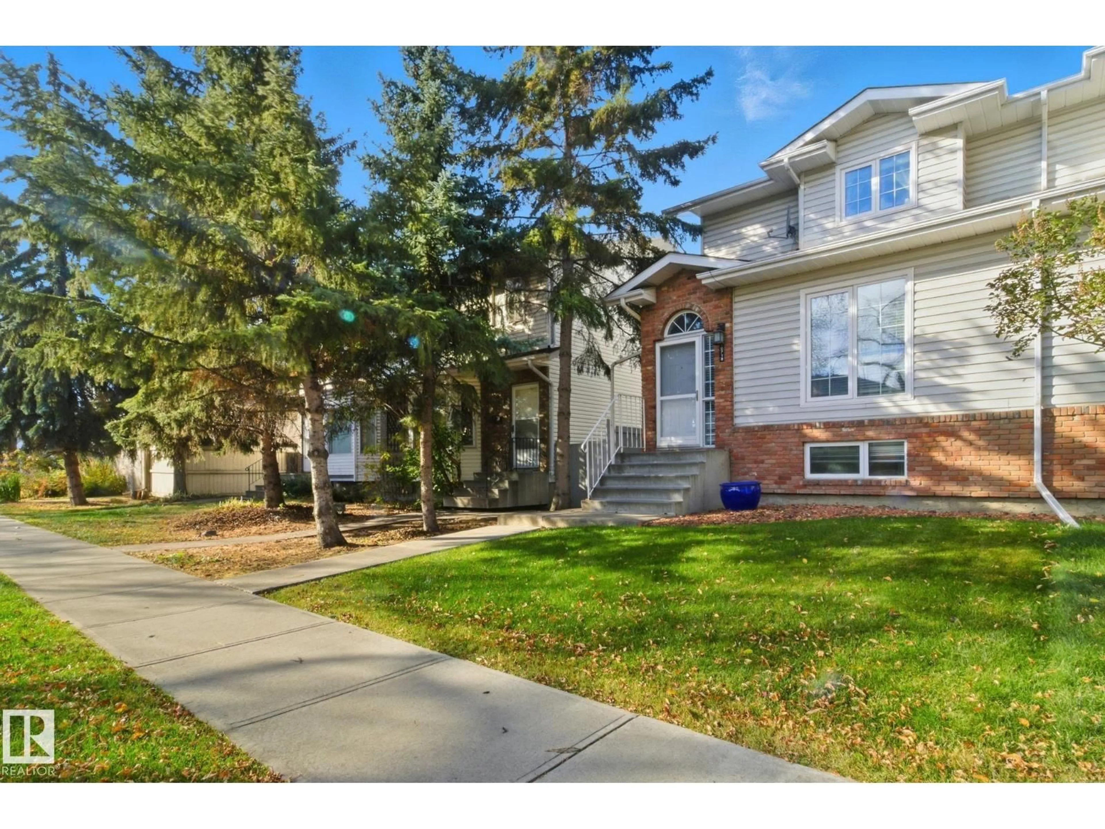 Home with vinyl exterior material, street for NW - 10718 122 ST, Edmonton Alberta T5M0A3