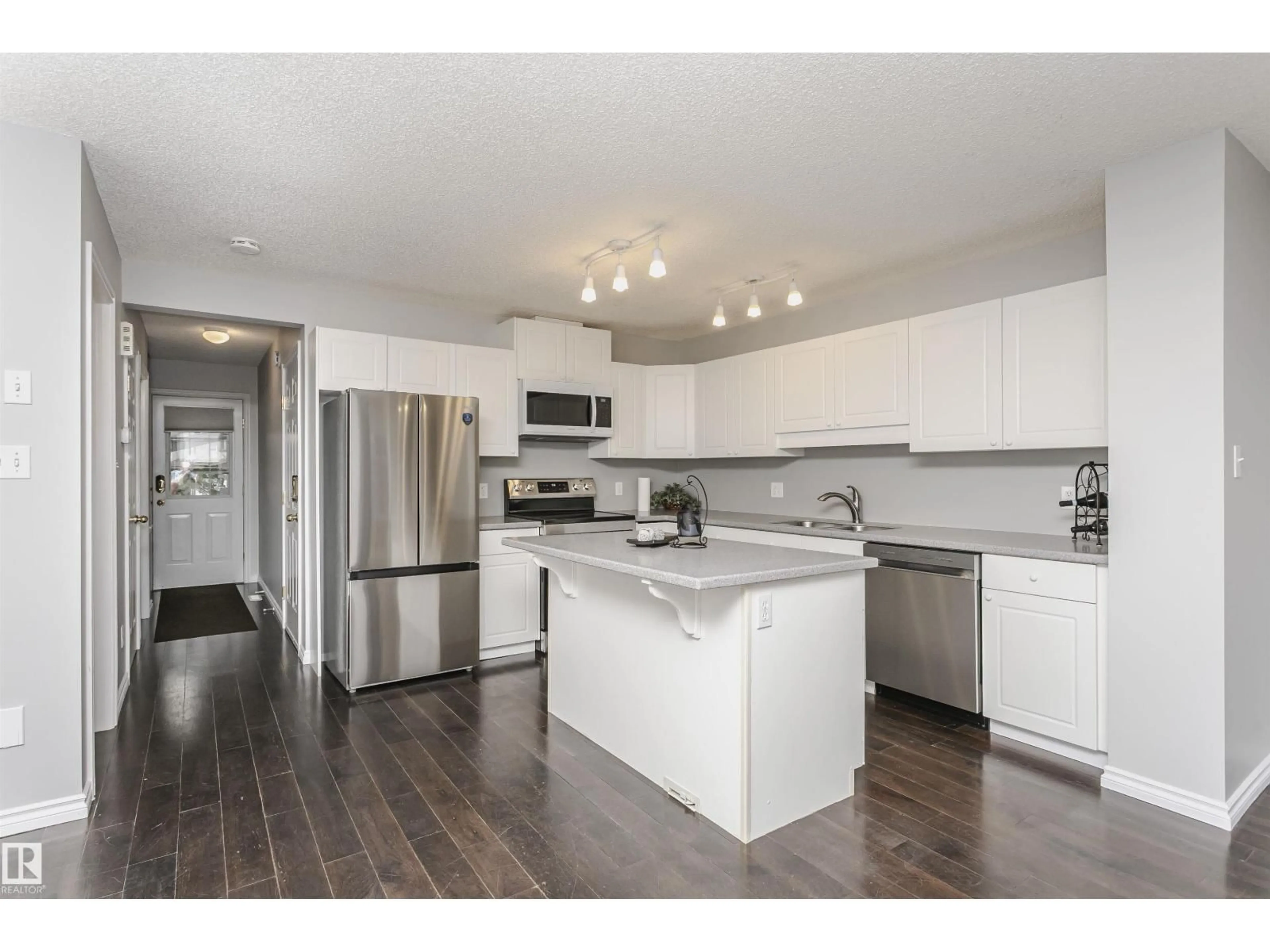 Open concept kitchen, wood/laminate floor for 9142 165 AV, Edmonton Alberta T5Z3H6
