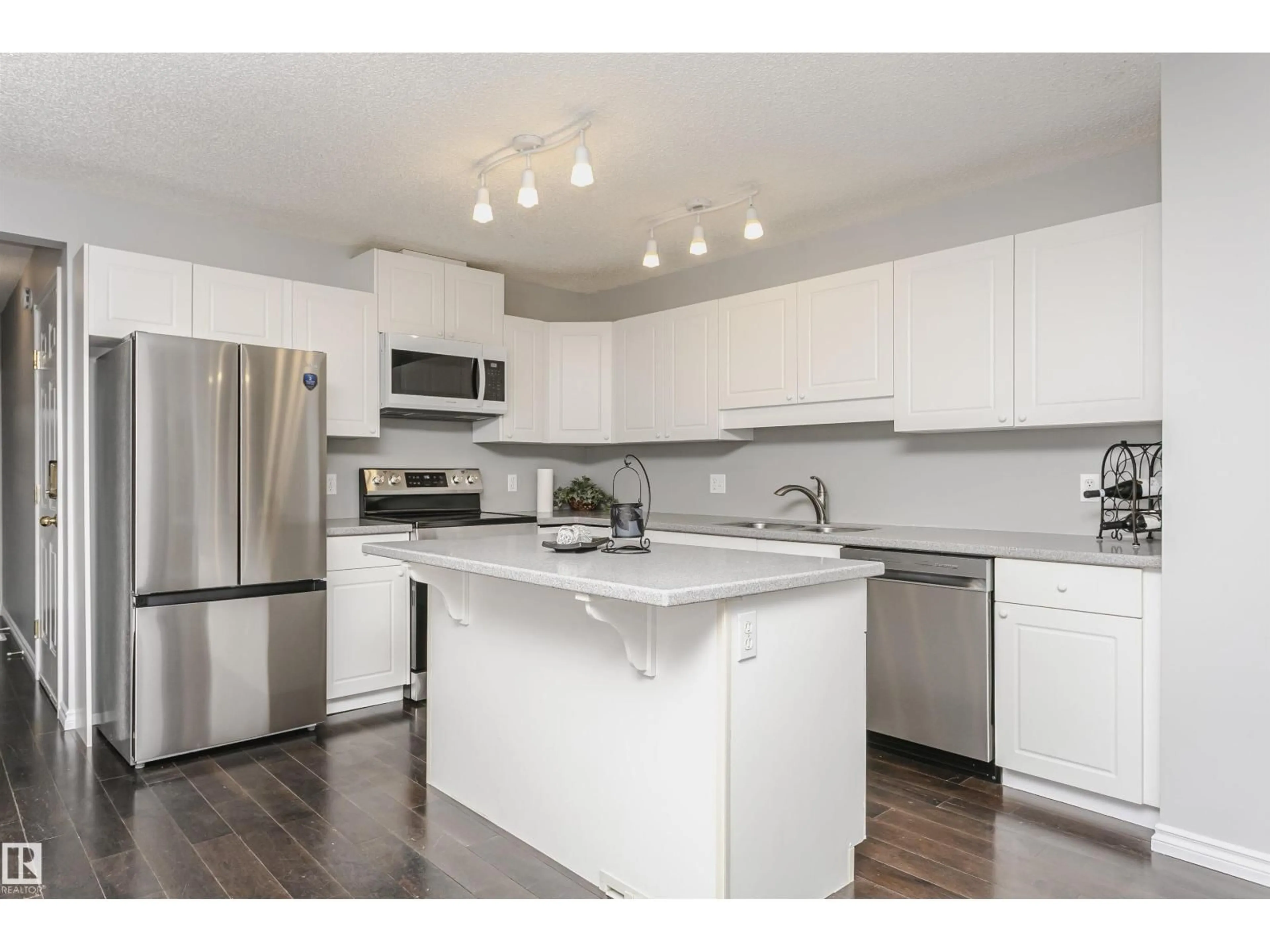 Open concept kitchen, wood/laminate floor for 9142 165 AV, Edmonton Alberta T5Z3H6