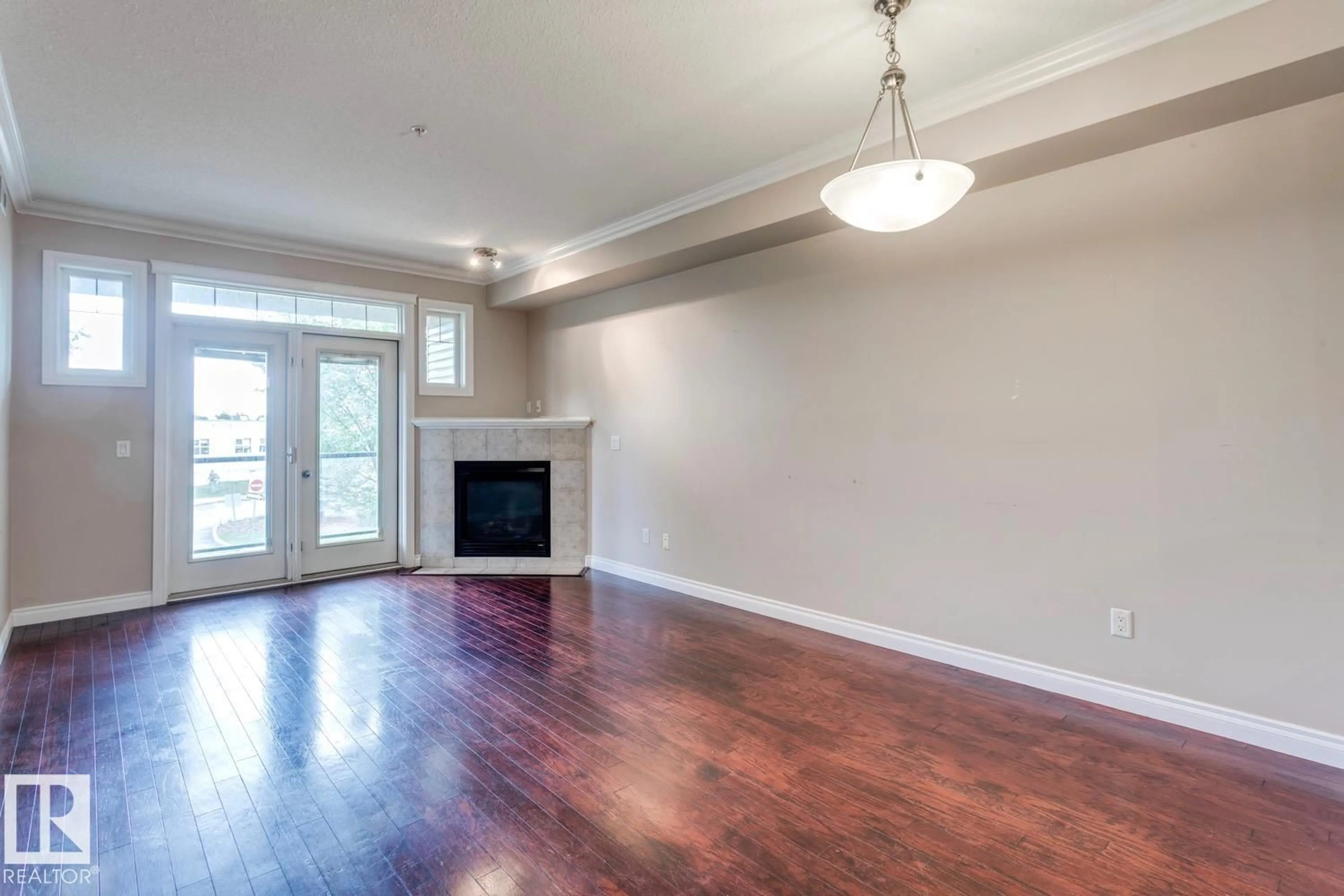 Living room with furniture, wood/laminate floor for #212 - 12408 15 AV, Edmonton Alberta T6W1X2